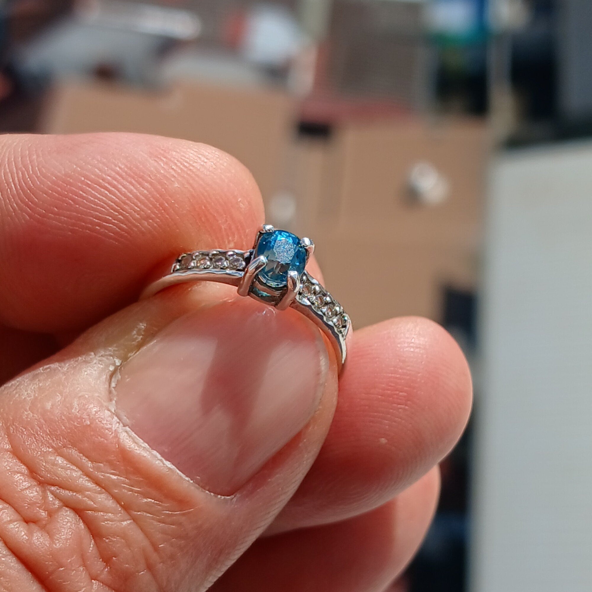A stunning Blue Zircon Ring featuring an oval cut gemstone set in polished 925 Sterling Silver with sparkling CZ accents.