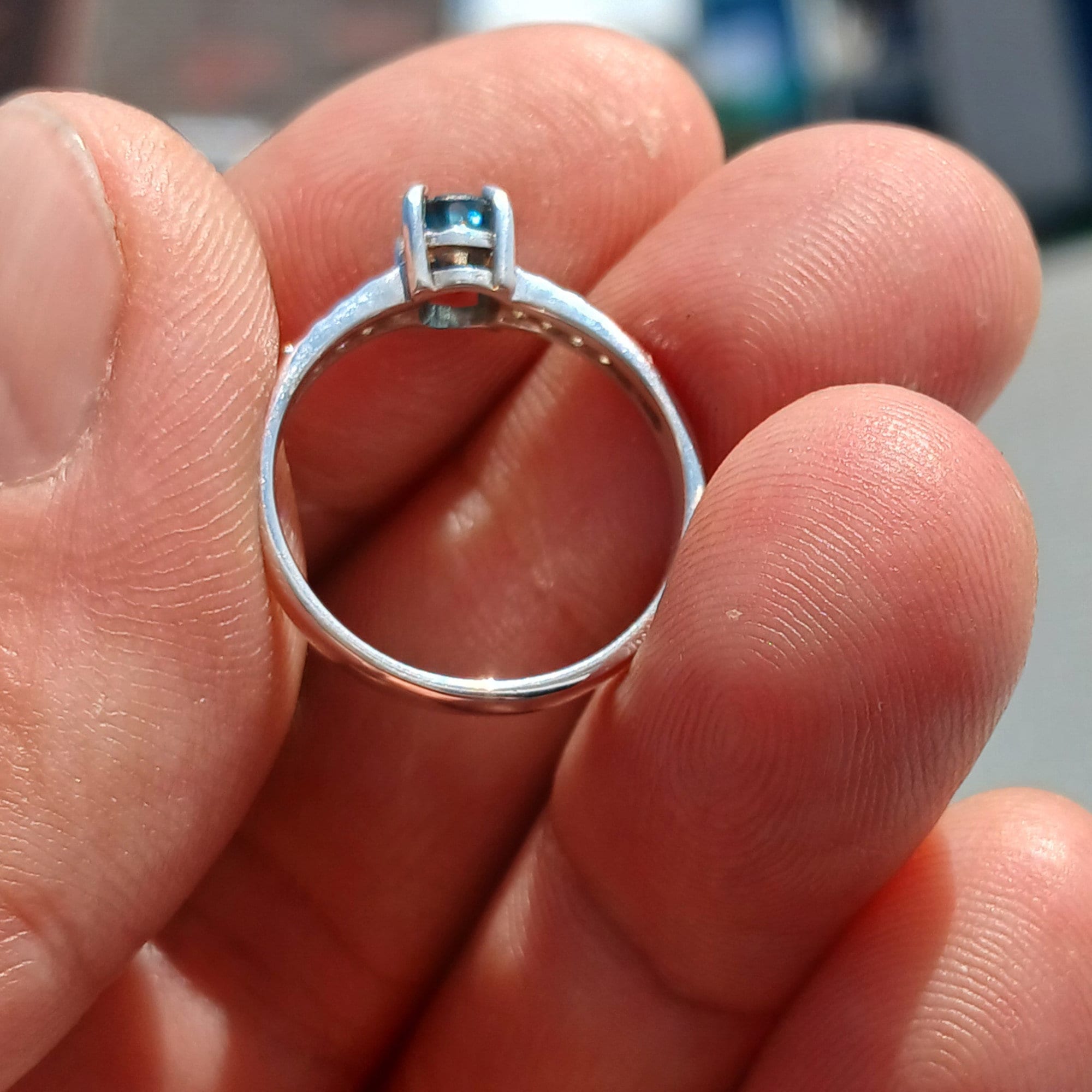 A stunning Blue Zircon Ring featuring an oval cut gemstone set in polished 925 Sterling Silver with sparkling CZ accents.