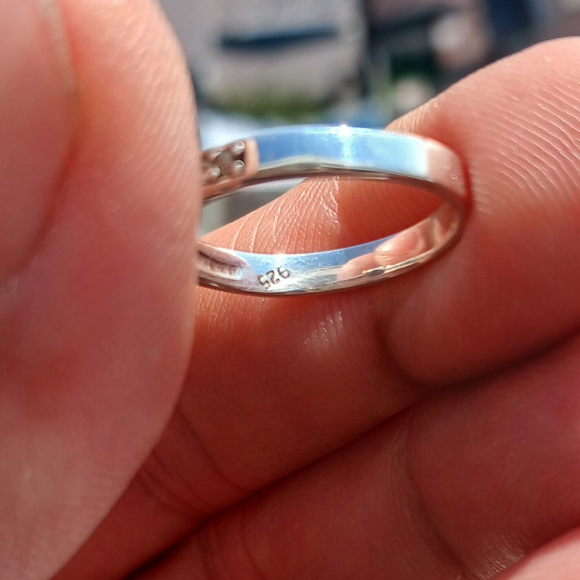 A stunning Blue Zircon Ring featuring an oval cut gemstone set in polished 925 Sterling Silver with sparkling CZ accents.