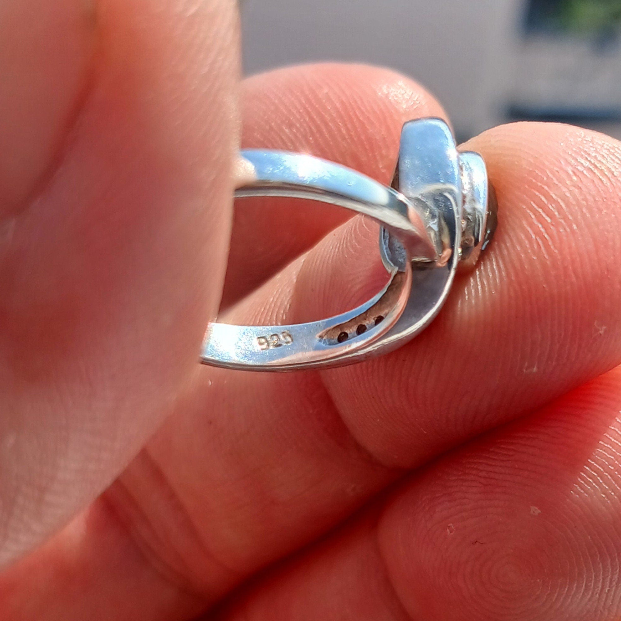 Handmade Blue Zircon Ring in sterling silver featuring an oval cut stone and 13 white CZ accents, perfect for elegant occasions.