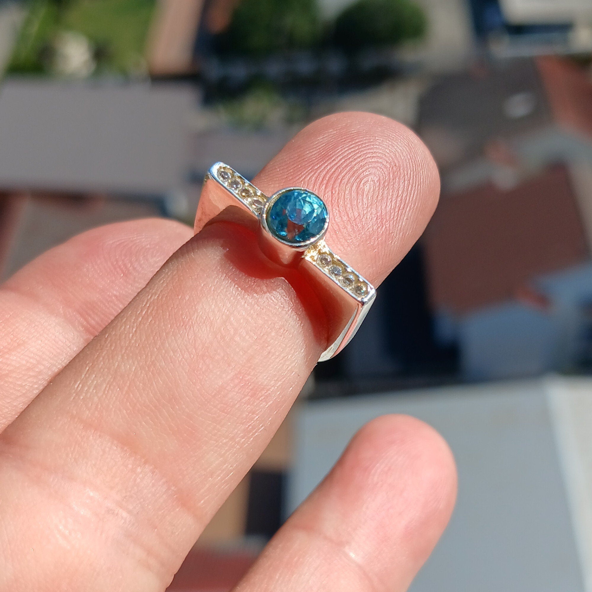 Elegant Blue Zircon Ring in polished sterling silver, featuring an oval cut gemstone.