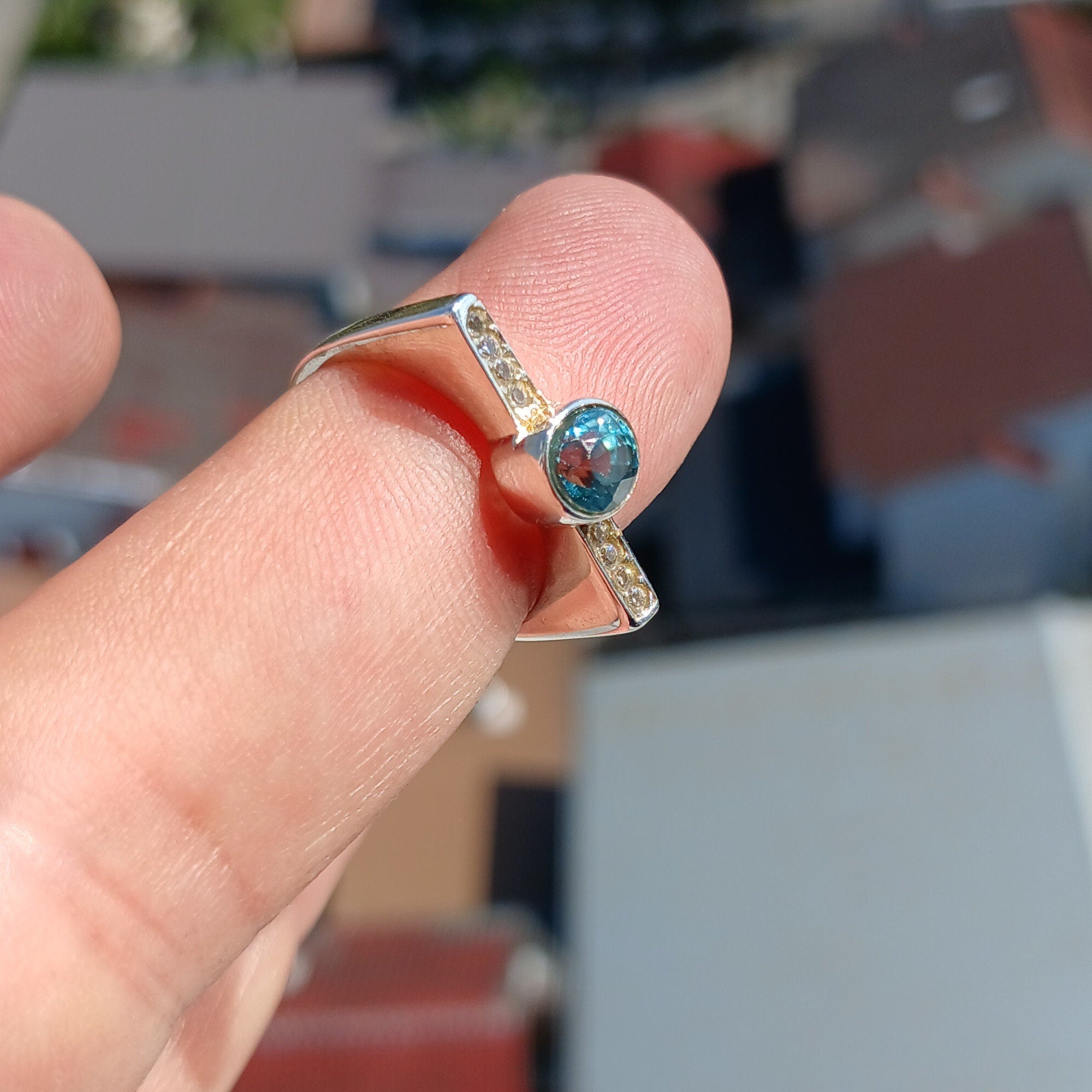 Elegant Blue Zircon Ring in polished sterling silver, featuring an oval cut gemstone.