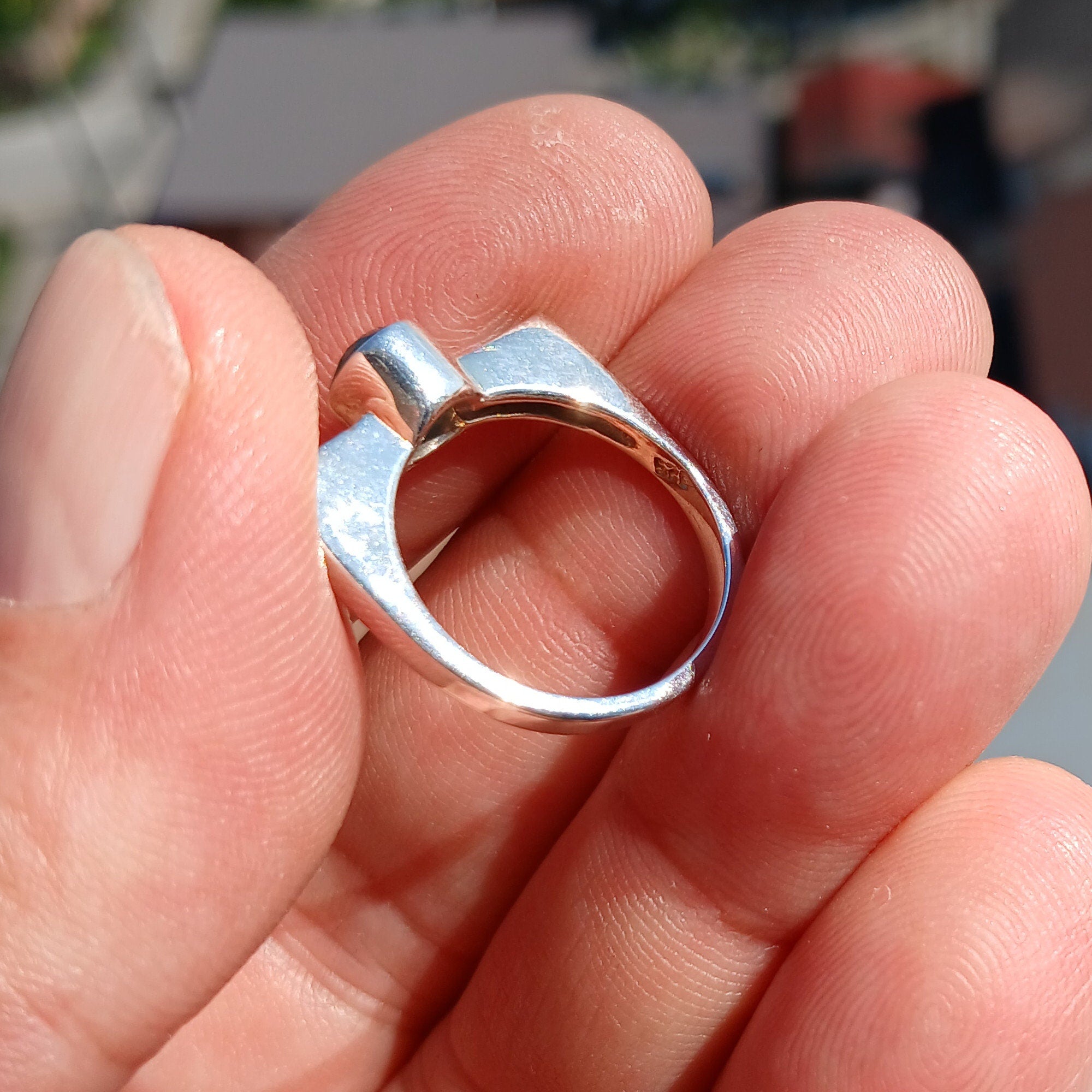 Elegant Blue Zircon Ring in polished sterling silver, featuring an oval cut gemstone.