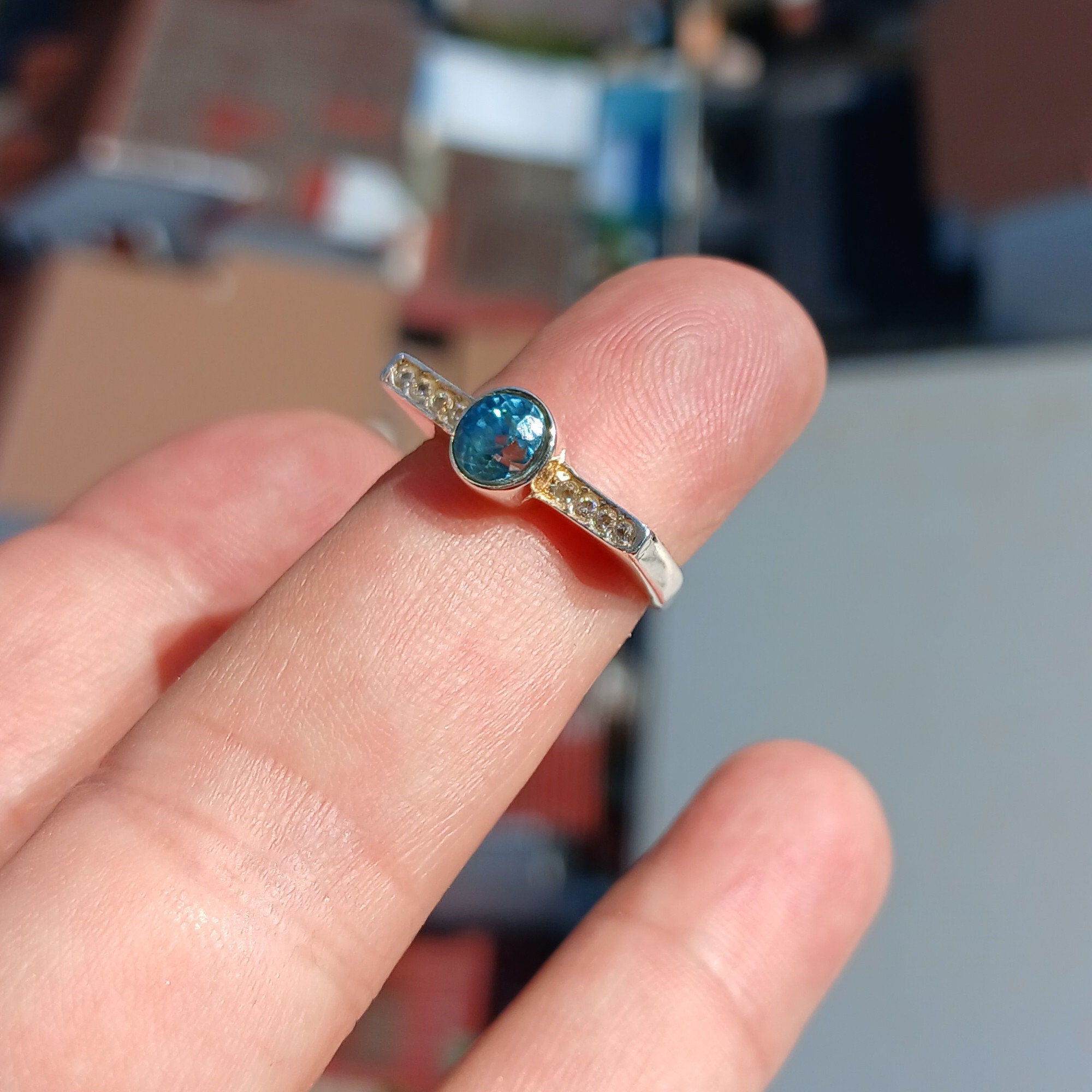 Elegant Blue Zircon Ring in polished sterling silver, featuring an oval cut gemstone.