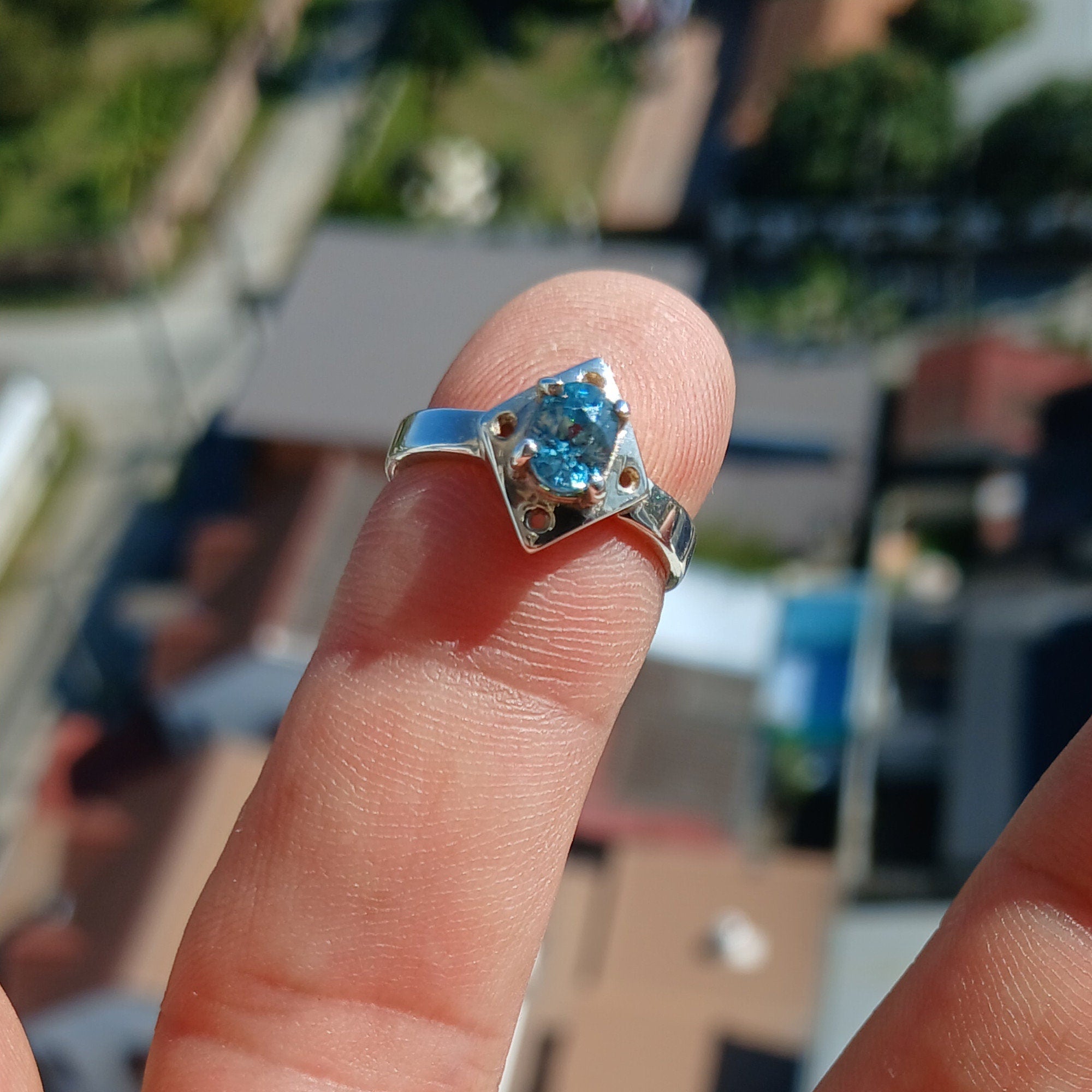 A stunning Blue Zircon Ring featuring an oval cut gemstone set in polished sterling silver, showcasing elegance and quality craftsmanship.