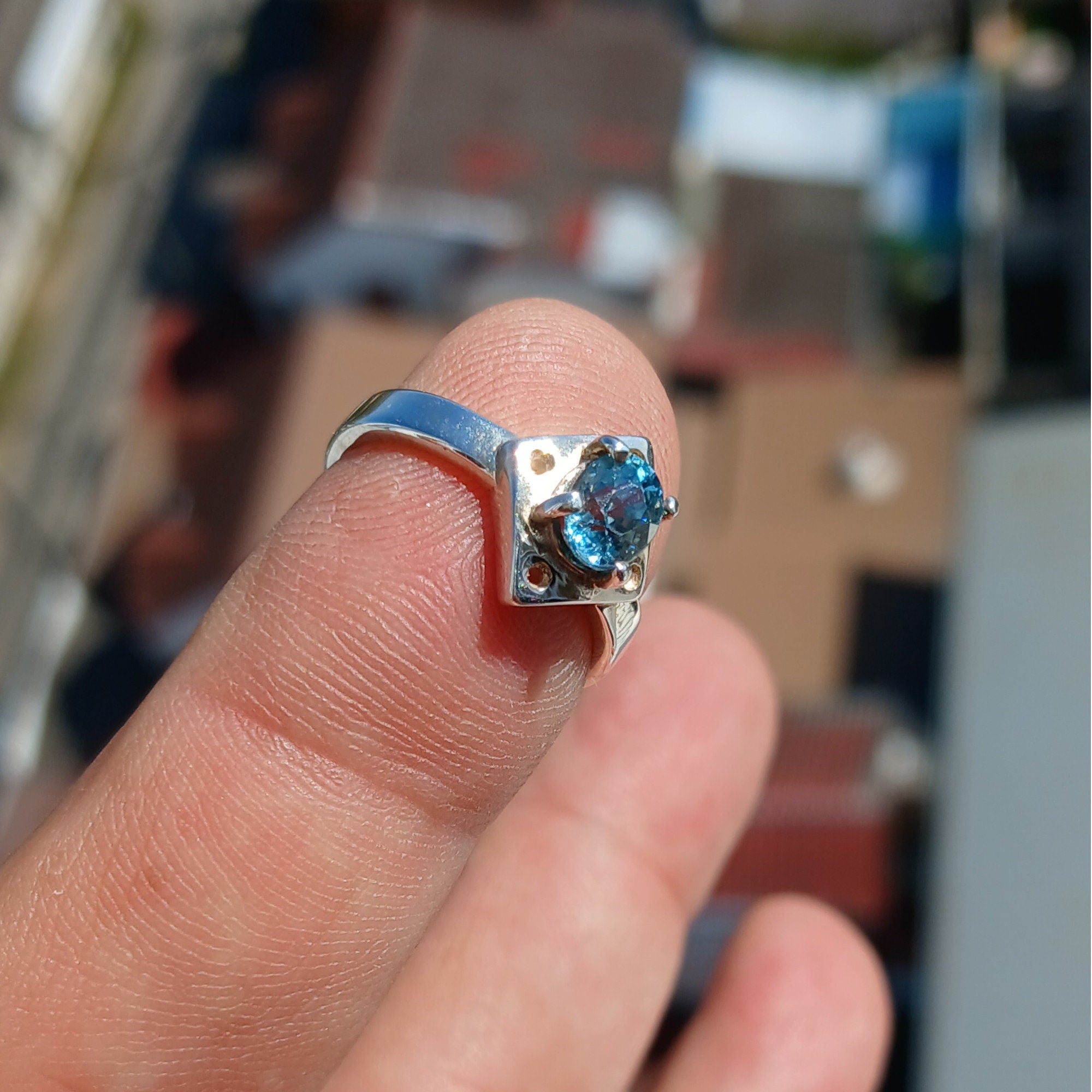 A stunning Blue Zircon Ring featuring an oval cut gemstone set in polished sterling silver, showcasing elegance and quality craftsmanship.