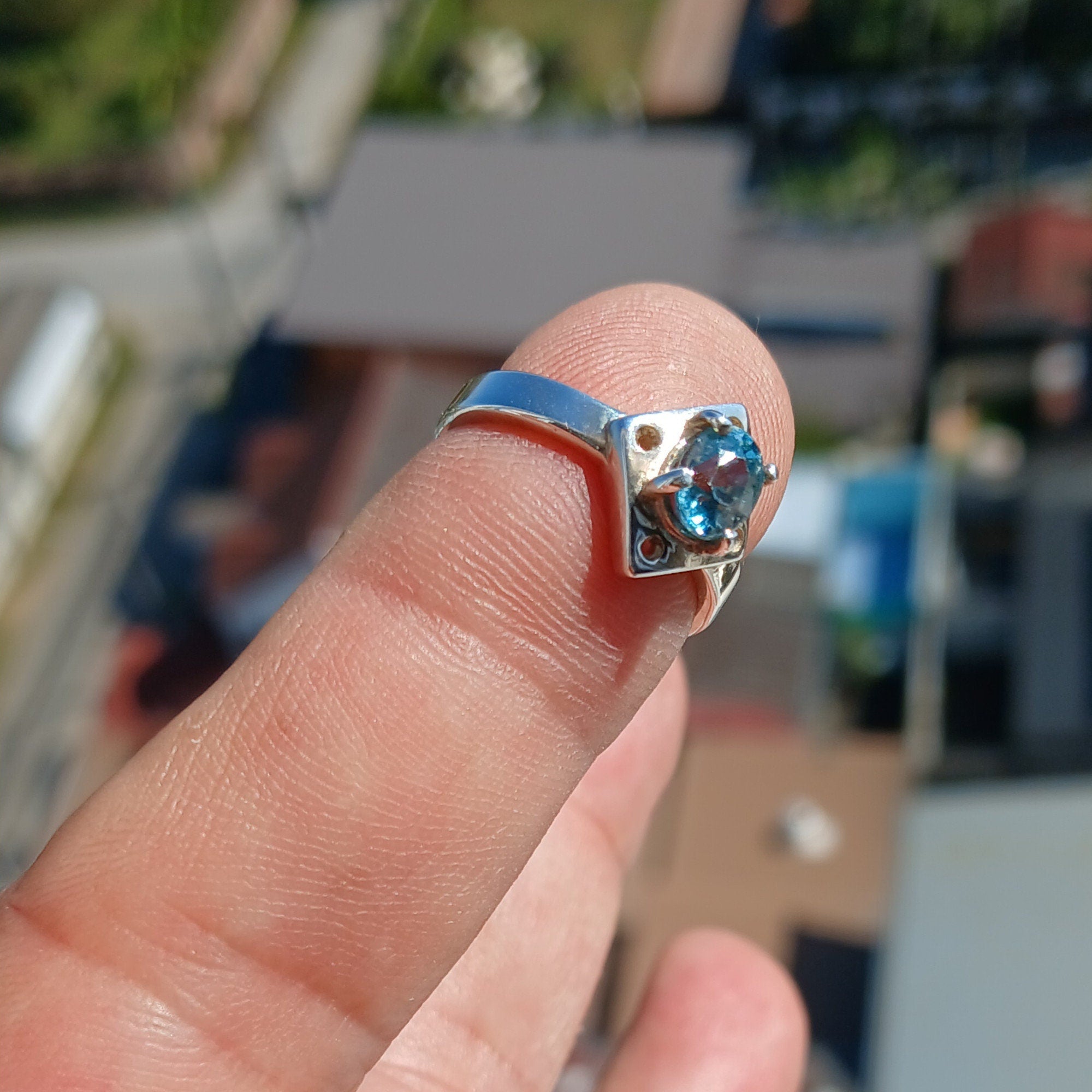 A stunning Blue Zircon Ring featuring an oval cut gemstone set in polished sterling silver, showcasing elegance and quality craftsmanship.