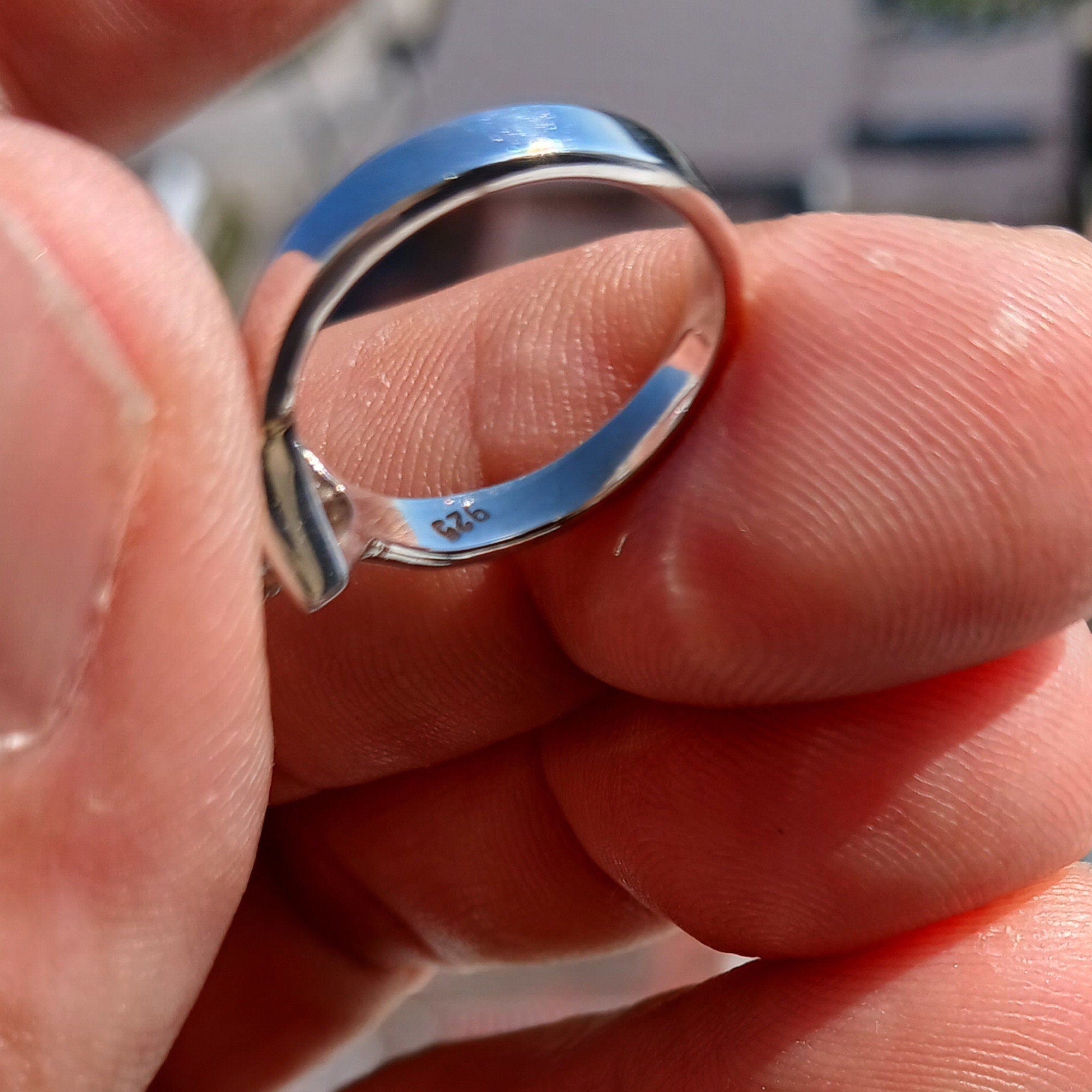 A stunning Blue Zircon Ring featuring an oval cut gemstone set in polished sterling silver, showcasing elegance and quality craftsmanship.