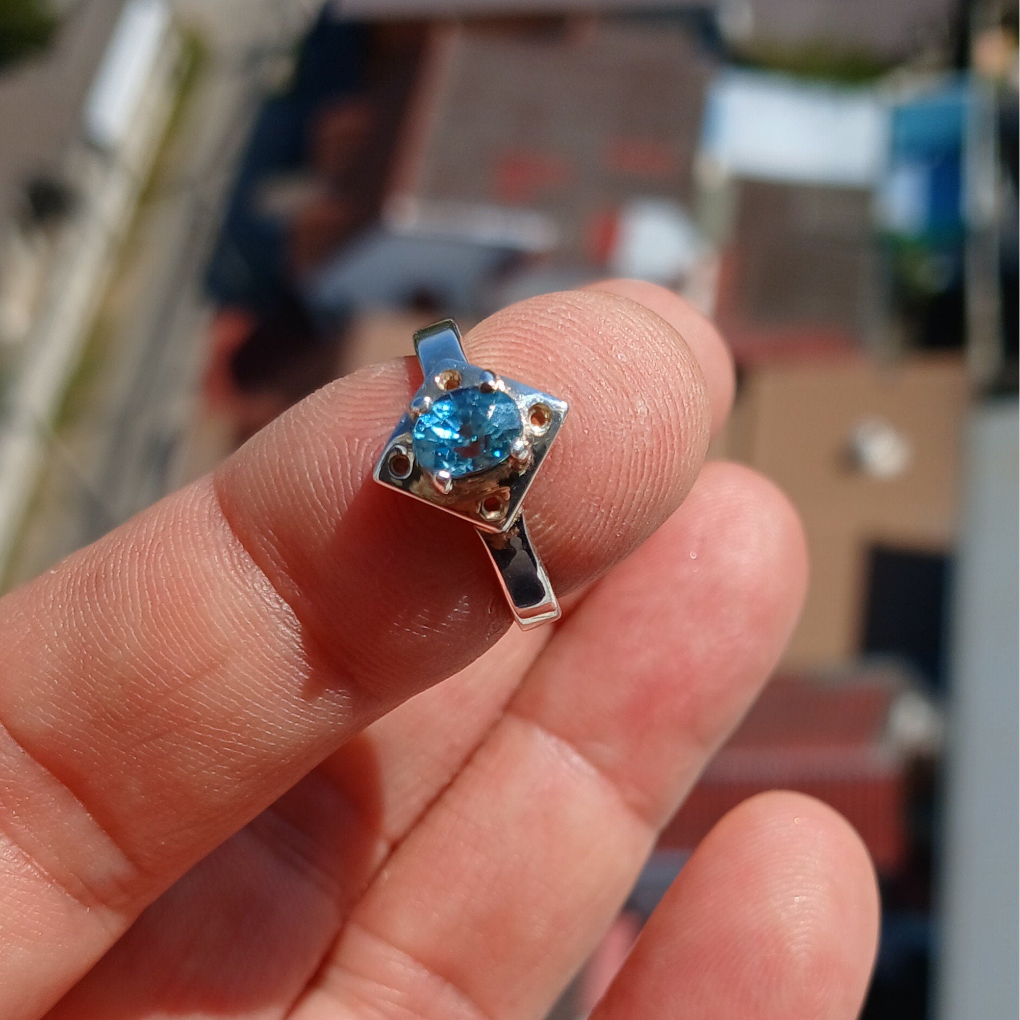 A stunning Blue Zircon Ring featuring an oval cut gemstone set in polished sterling silver, showcasing elegance and quality craftsmanship.