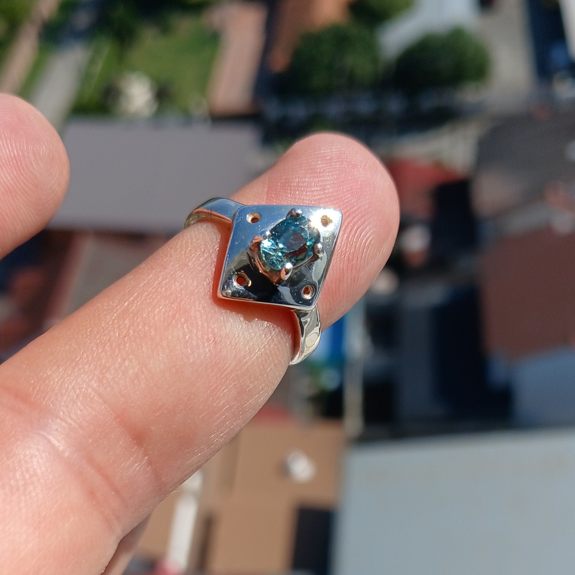 A beautiful Blue Zircon Ring featuring an oval cut gemstone set in a polished Sterling Silver band, showcasing its elegant design.