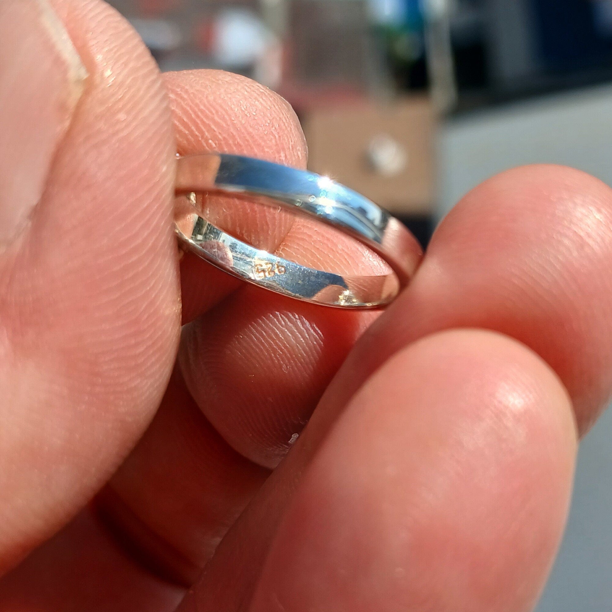 A stunning Blue Zircon Ring featuring a natural gemstone set in polished sterling silver, adorned with 14 white CZ stones.
