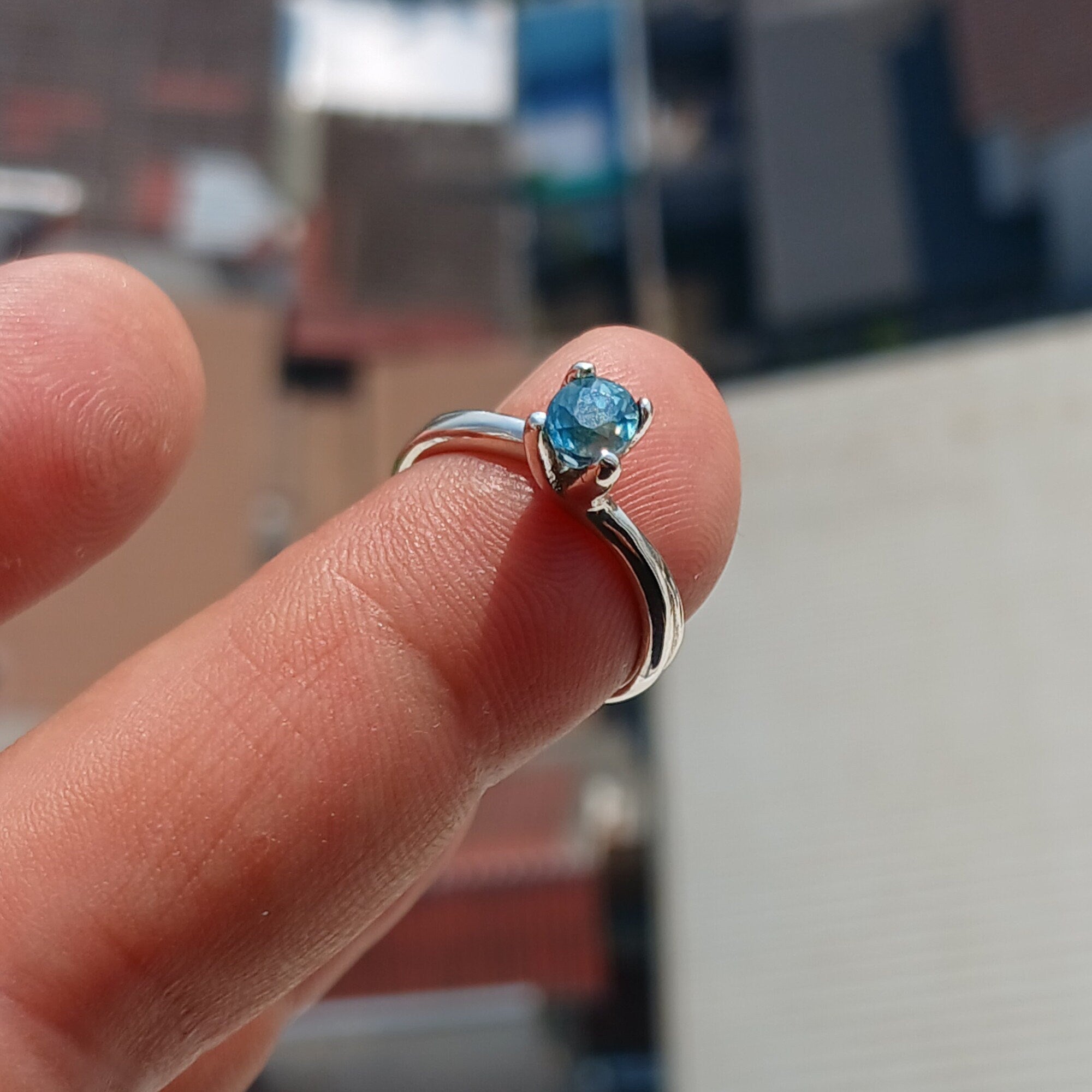 Elegant Blue Zircon Ring in sterling silver featuring an oval cut gemstone, perfect for any occasion.