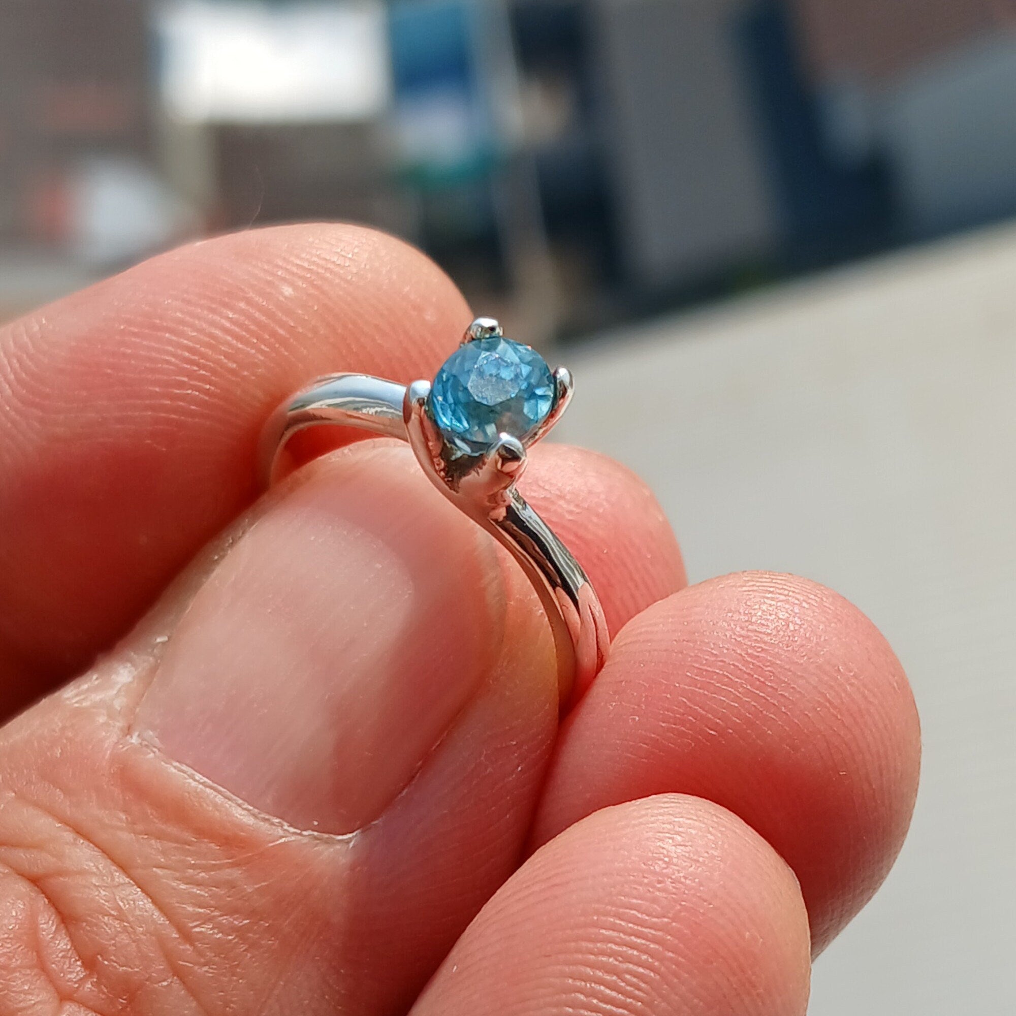 Elegant Blue Zircon Ring in sterling silver featuring an oval cut gemstone, perfect for any occasion.