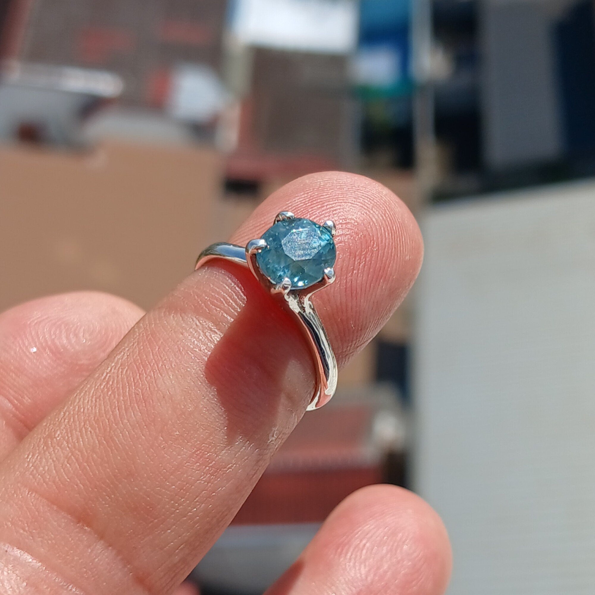 A stunning Blue Zircon Ring set in polished sterling silver, featuring an oval-cut blue gemstone in a solitaire design.