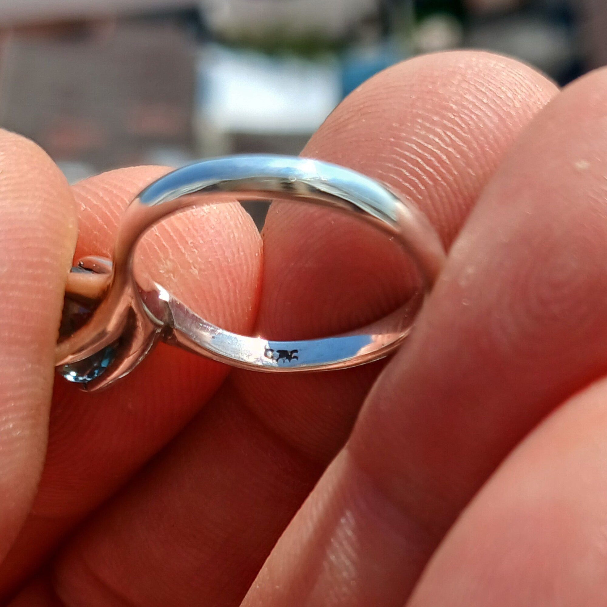 A stunning Blue Zircon Ring set in polished sterling silver, featuring an oval-cut blue gemstone in a solitaire design.