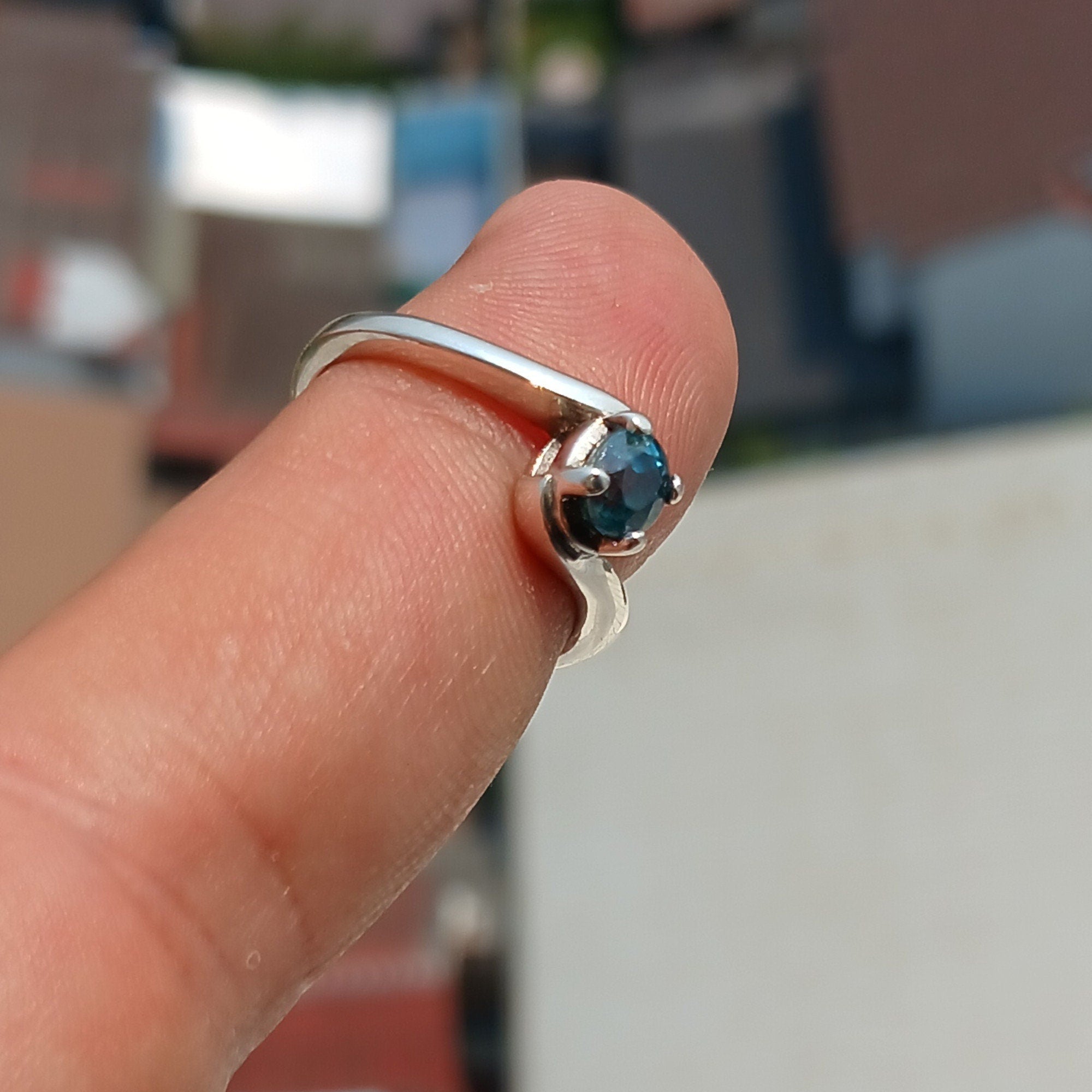 A beautiful Blue Zircon Ring set in polished 925 Sterling Silver, featuring an oval cut blue gemstone, perfect for elegant occasions.