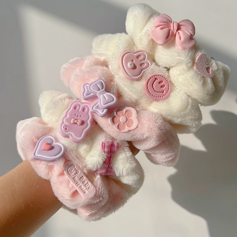 A colorful set of five Blushing Blooms scrunchies featuring floral designs, perfect for stylish hair accessories.