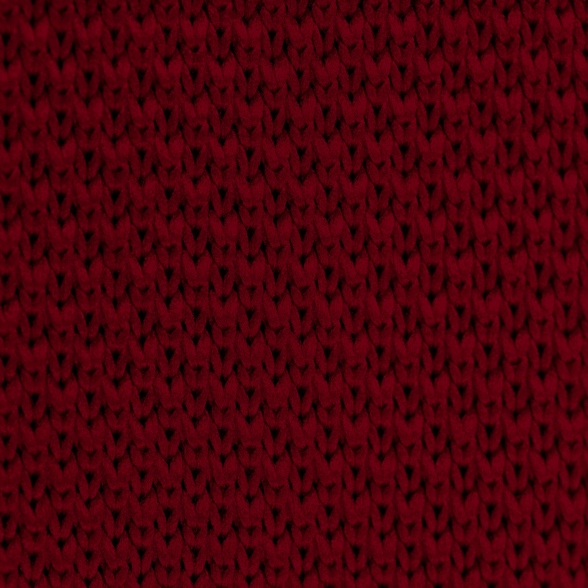 Burgundy knitted tie and pocket square set displayed elegantly, showcasing the rich color and texture.