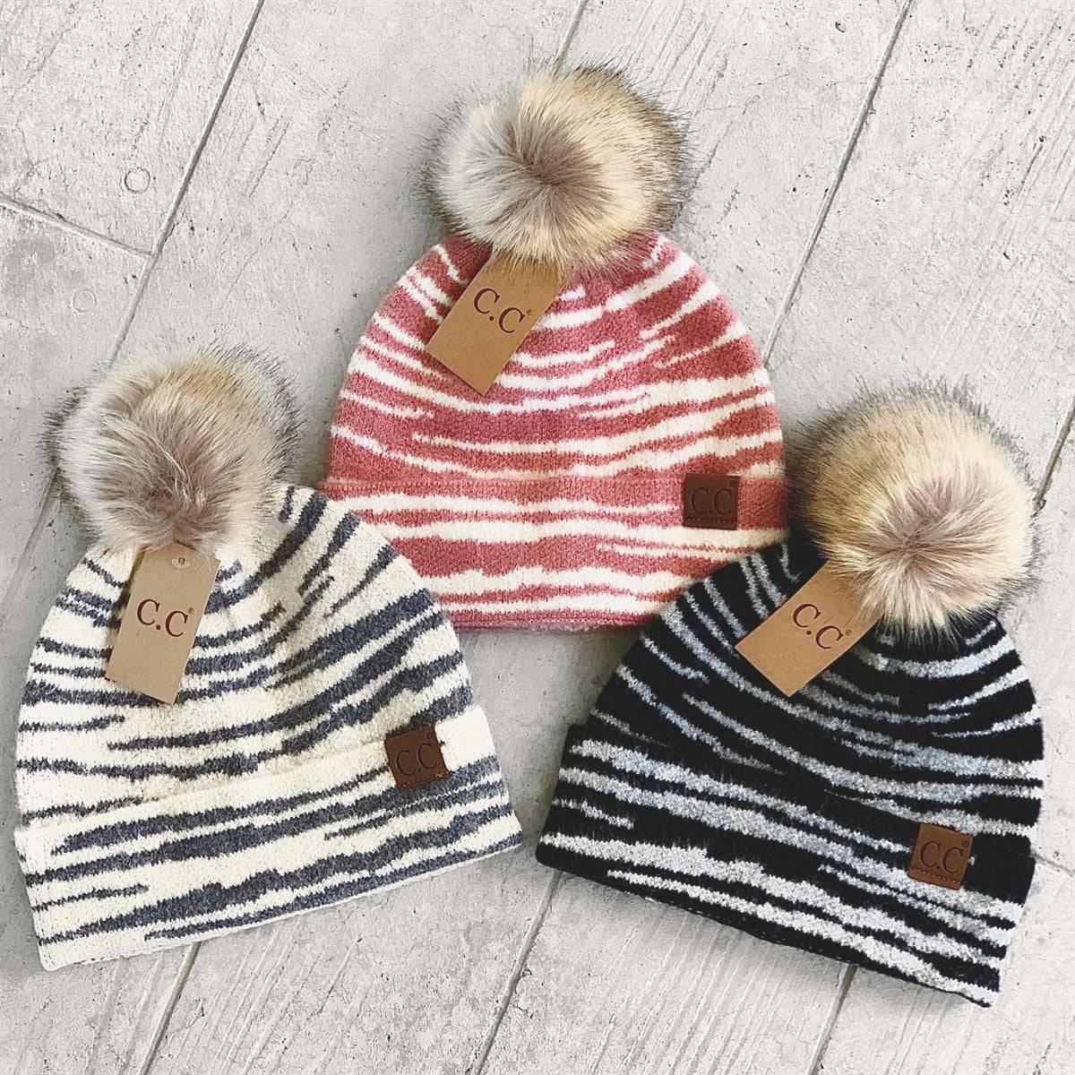 CC Beanie Animal Print Winter Hat featuring a stylish design with a faux fur pom, perfect for cold weather.