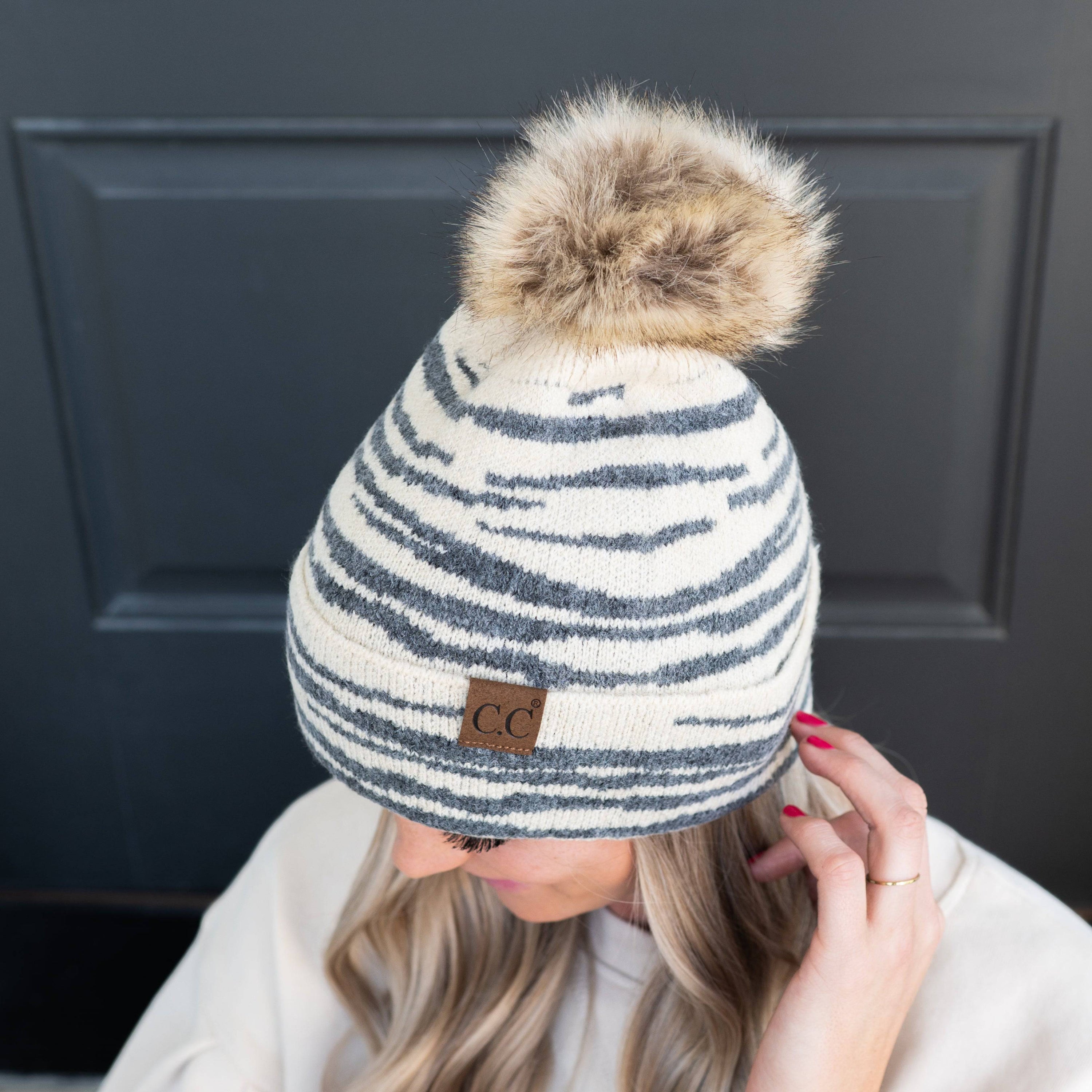 CC Beanie Animal Print Winter Hat featuring a stylish design with a faux fur pom, perfect for cold weather.