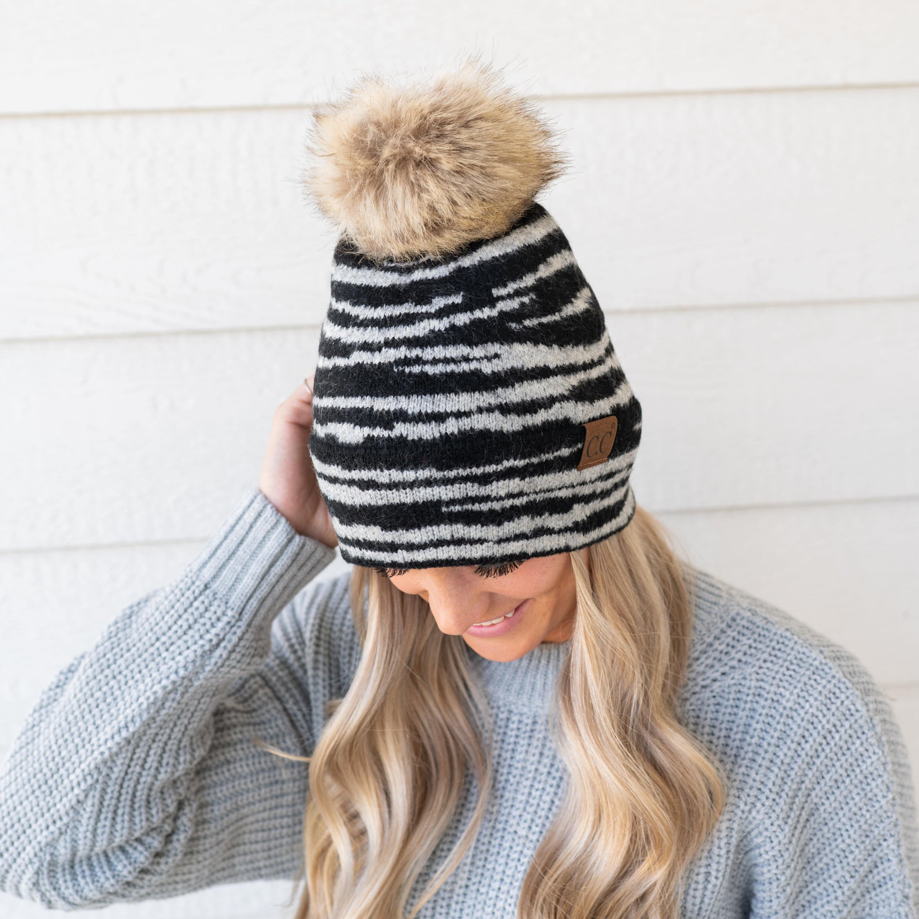 CC Beanie Animal Print Winter Hat featuring a stylish design with a faux fur pom, perfect for cold weather.