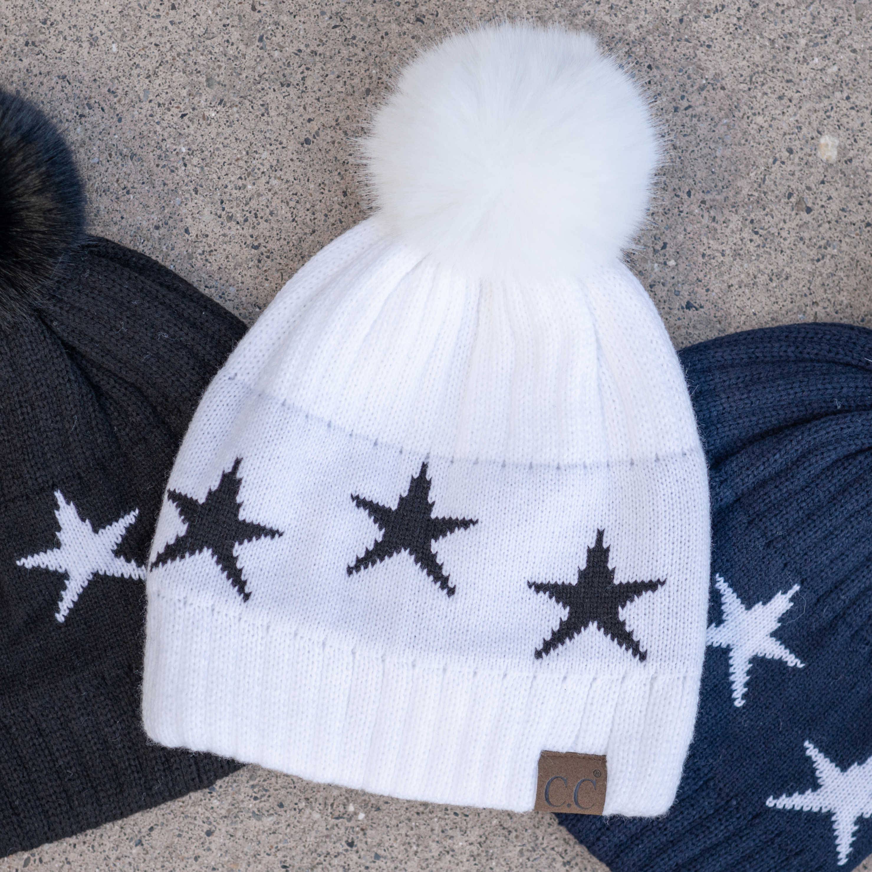 CC Beanie featuring a luxurious faux fur pom and trendy star pattern, perfect for stylish winter wear.