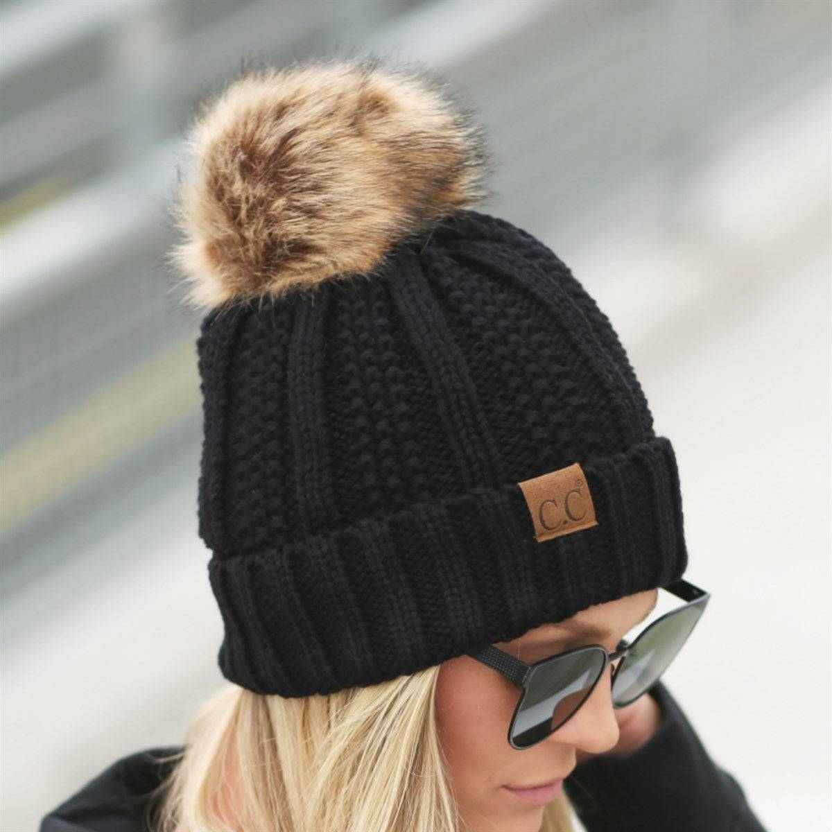 CC Bold Pom Accented Beanie with faux fur pom, cozy fleece lining, and authentic C.C.® branding, suitable for kids and adults.