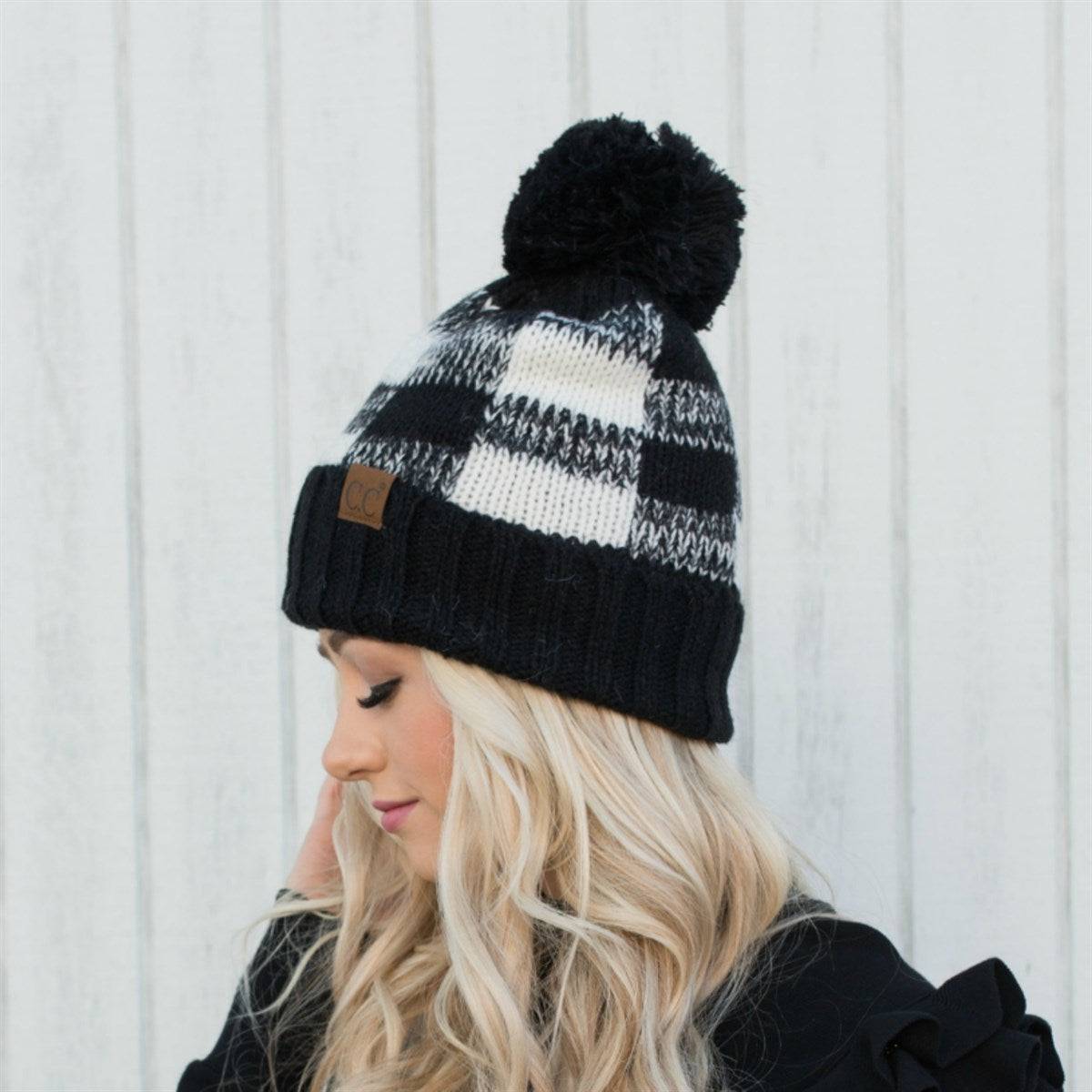 CC Buffalo Plaid Beanie with faux fur pom, fleece lined, showcasing a trendy buffalo check pattern.