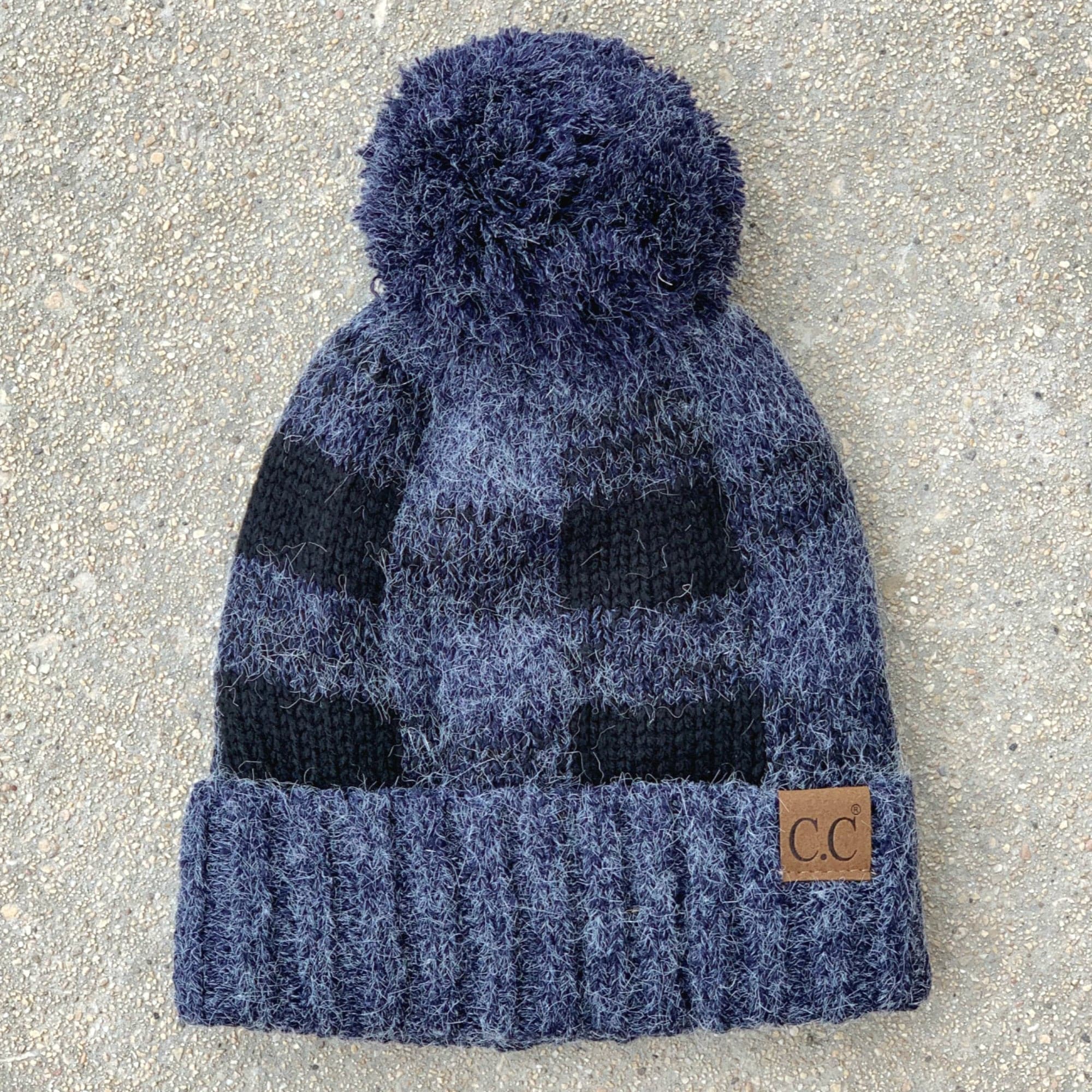 CC Buffalo Plaid Beanie with faux fur pom, fleece lined, showcasing a trendy buffalo check pattern.