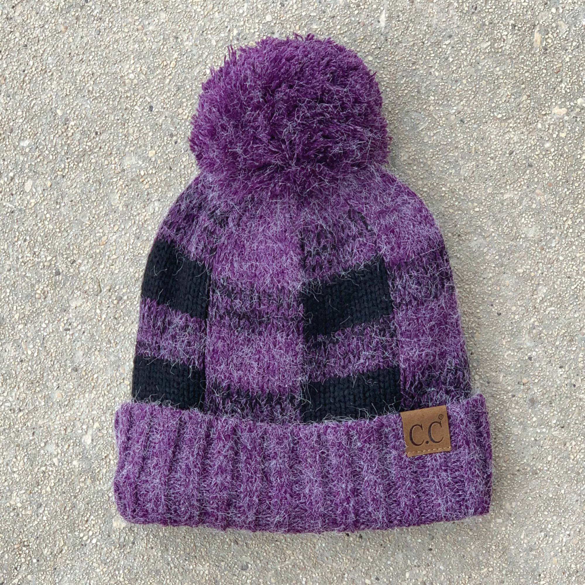 CC Buffalo Plaid Beanie with faux fur pom, fleece lined, showcasing a trendy buffalo check pattern.