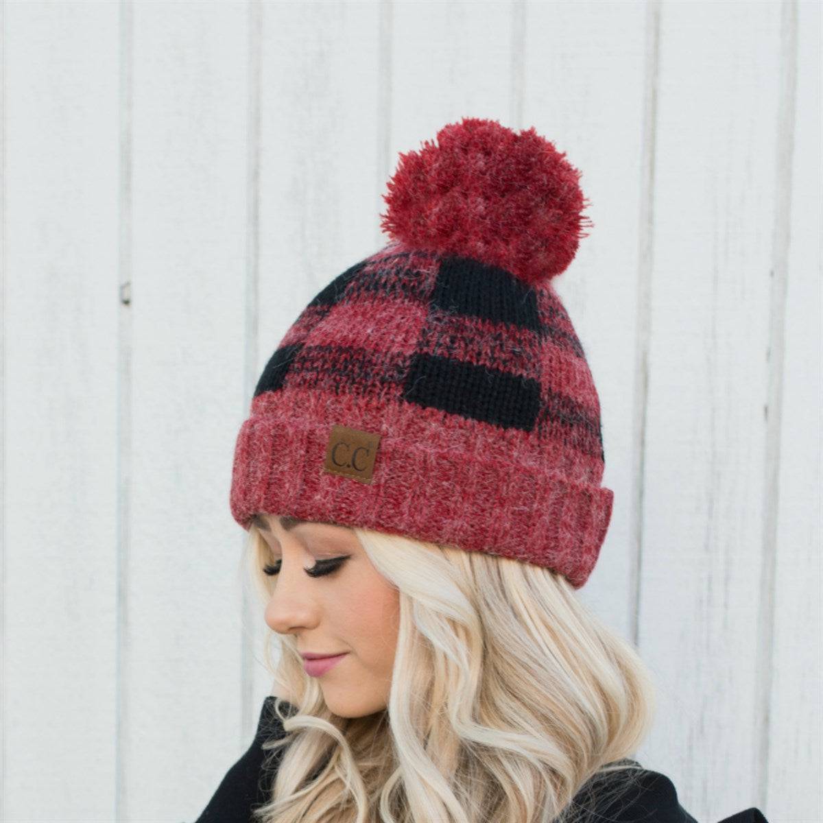 CC Buffalo Plaid Beanie with faux fur pom, fleece lined, showcasing a trendy buffalo check pattern.