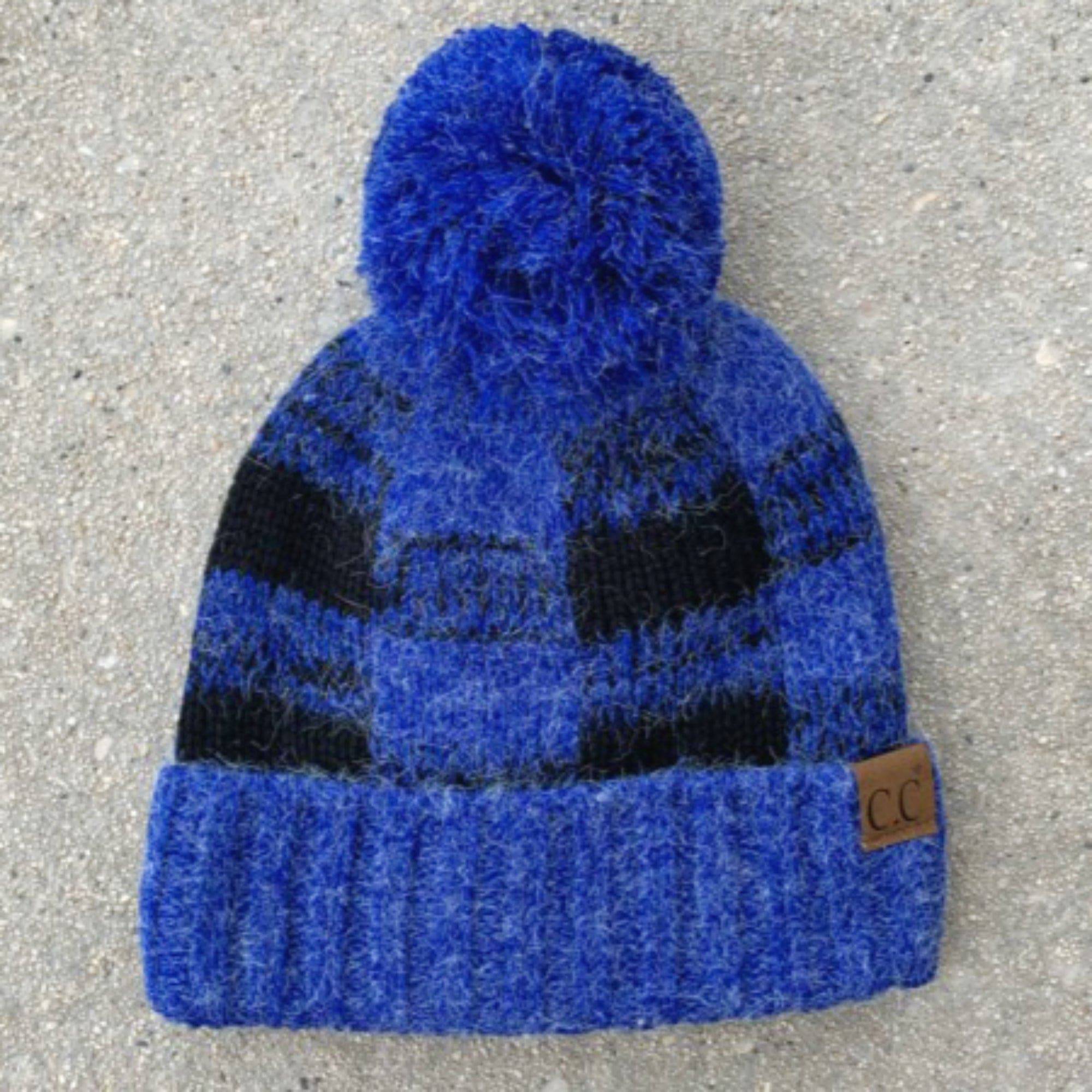 CC Buffalo Plaid Beanie with faux fur pom, fleece lined, showcasing a trendy buffalo check pattern.