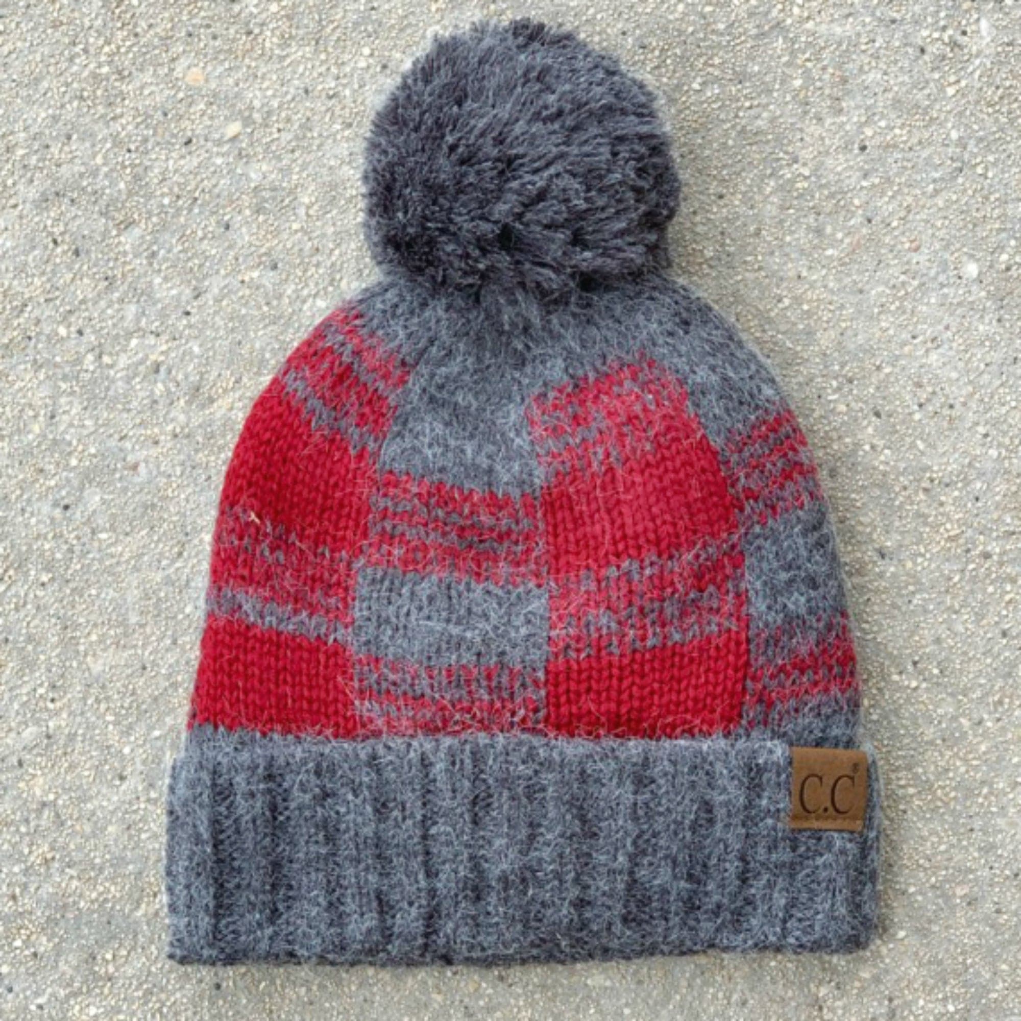 CC Buffalo Plaid Beanie with faux fur pom, fleece lined, showcasing a trendy buffalo check pattern.