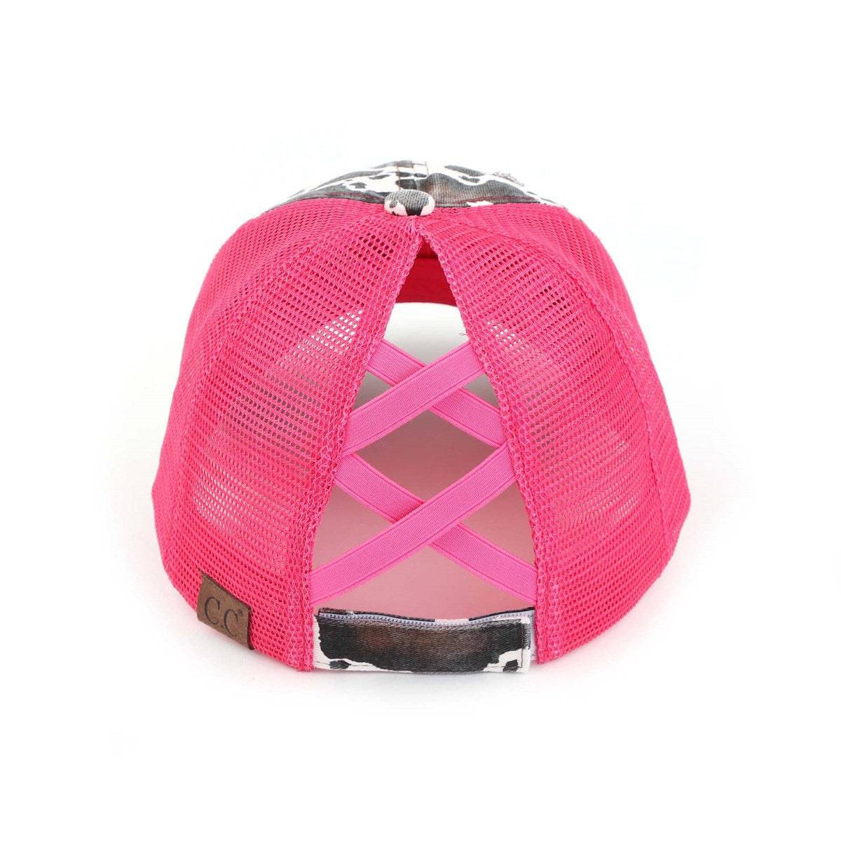 CC Cow Print Pony Hat featuring criss-cross elastic for ponytails, soft cotton material, and adjustable velcro strap.