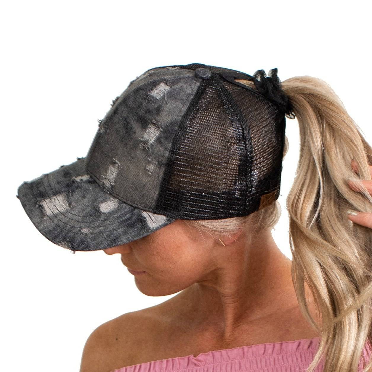 CC Destroyed Denim Messy Bun Pony Cap featuring distressed denim design, adjustable Velcro strap, and ponytail access, suitable for women, teens, and kids.