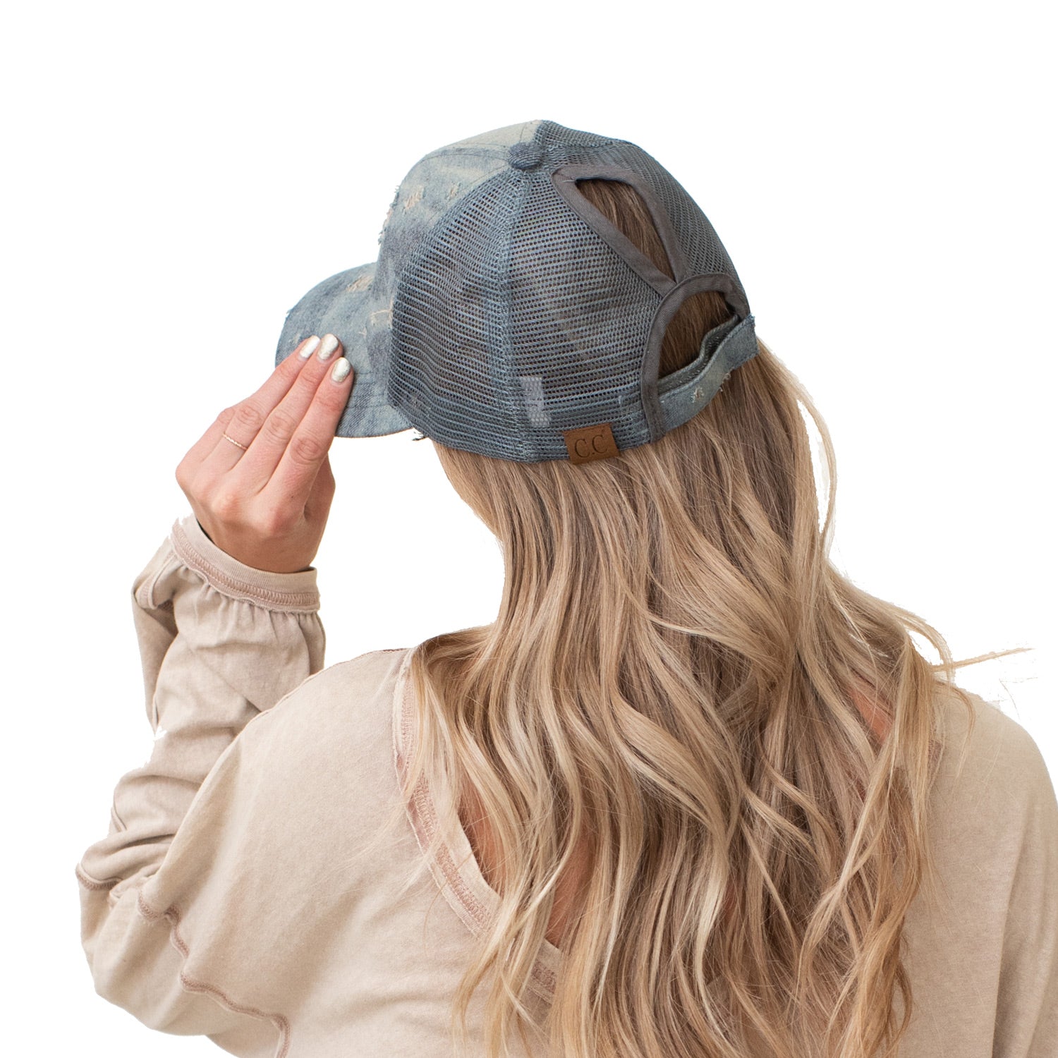 CC Destroyed Denim Messy Bun Pony Cap featuring distressed denim design, adjustable Velcro strap, and ponytail access, suitable for women, teens, and kids.