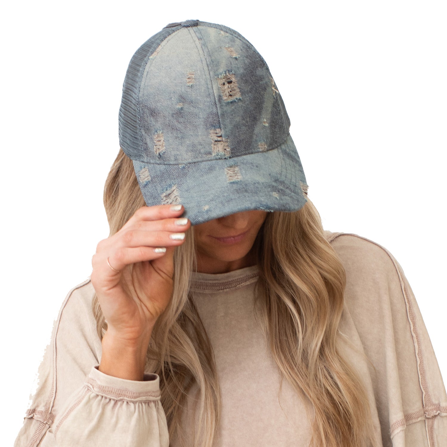 CC Destroyed Denim Messy Bun Pony Cap featuring distressed denim design, adjustable Velcro strap, and ponytail access, suitable for women, teens, and kids.