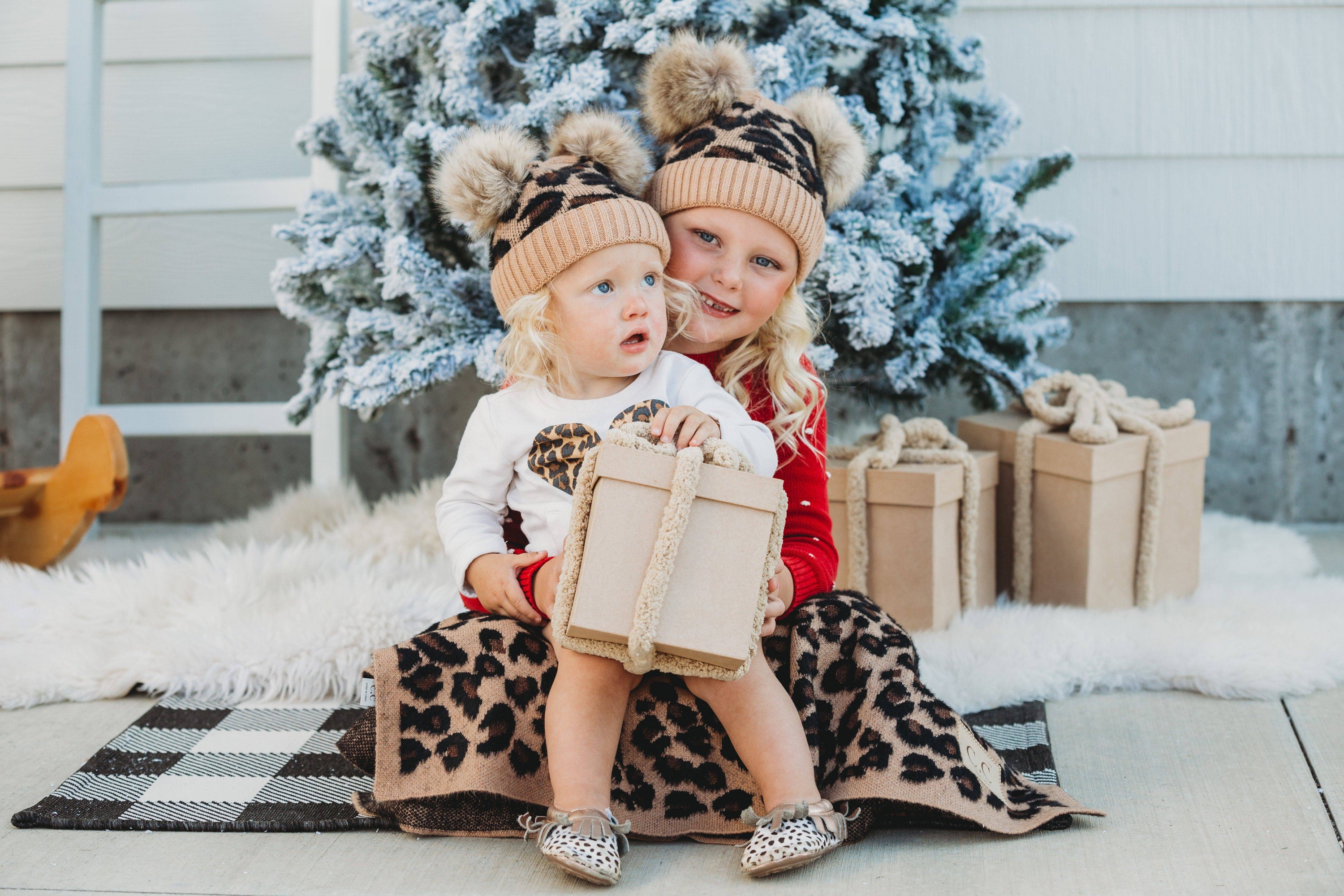CC Double Pom Baby & Kids Leopard Beanie with fluffy faux fur poms and stylish leopard print design, perfect for keeping kids warm.
