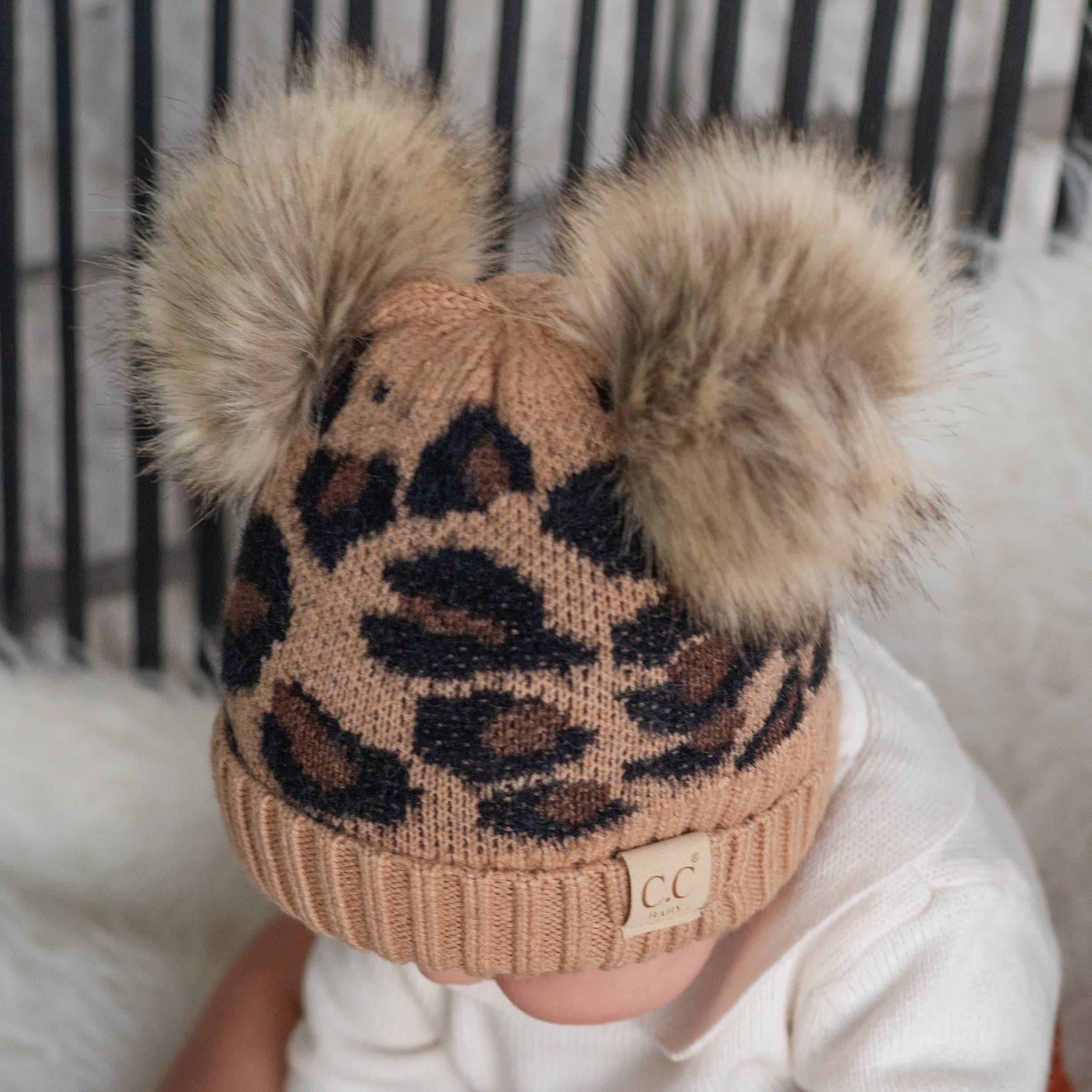 CC Double Pom Baby & Kids Leopard Beanie with fluffy faux fur poms and stylish leopard print design, perfect for keeping kids warm.