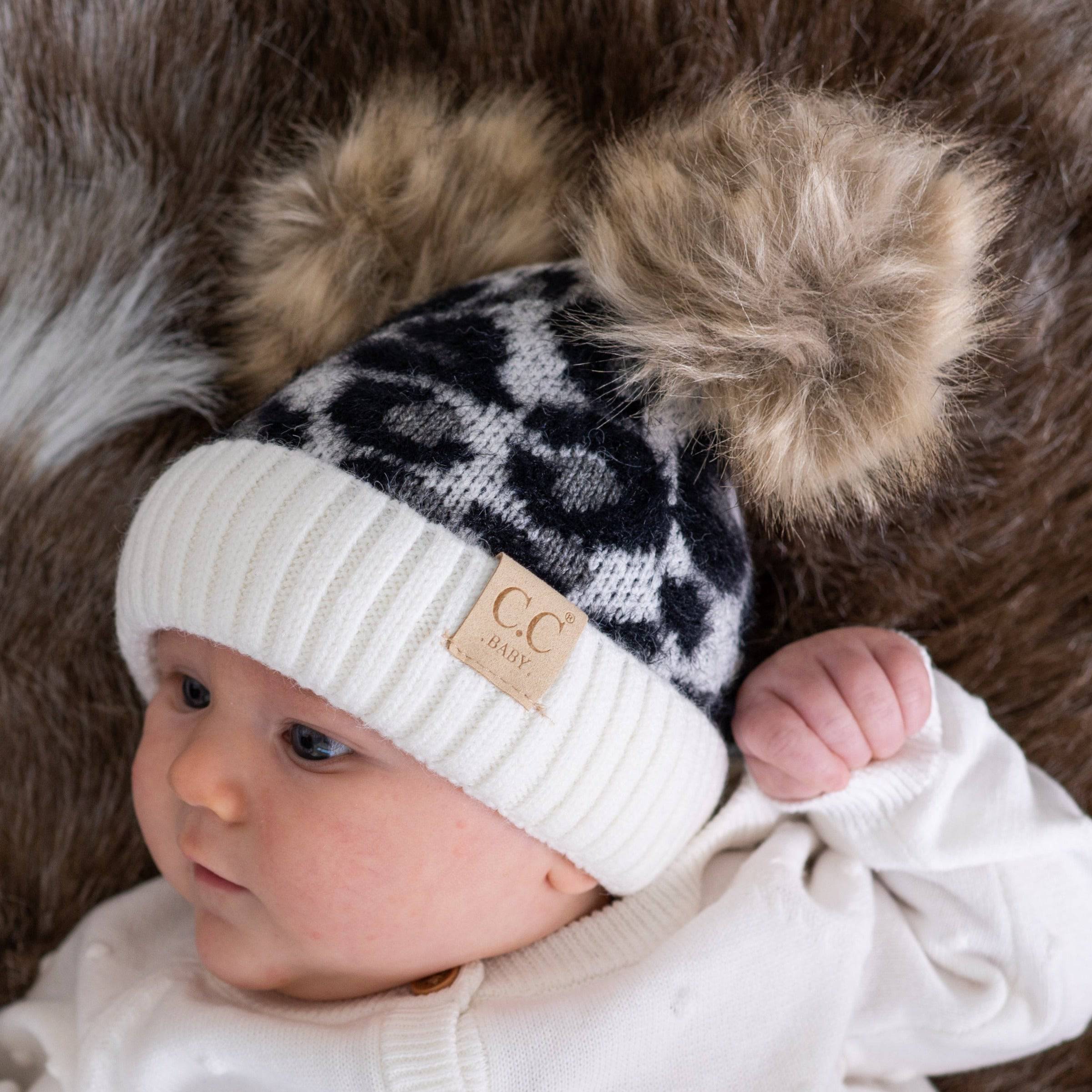 CC Double Pom Baby & Kids Leopard Beanie with fluffy faux fur poms and stylish leopard print design, perfect for keeping kids warm.