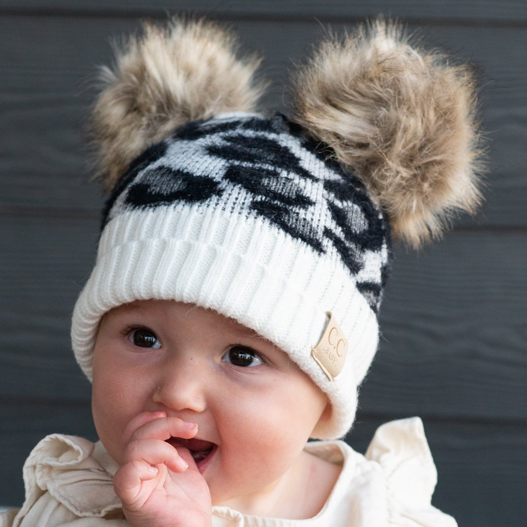 CC Double Pom Baby & Kids Leopard Beanie with fluffy faux fur poms and stylish leopard print design, perfect for keeping kids warm.