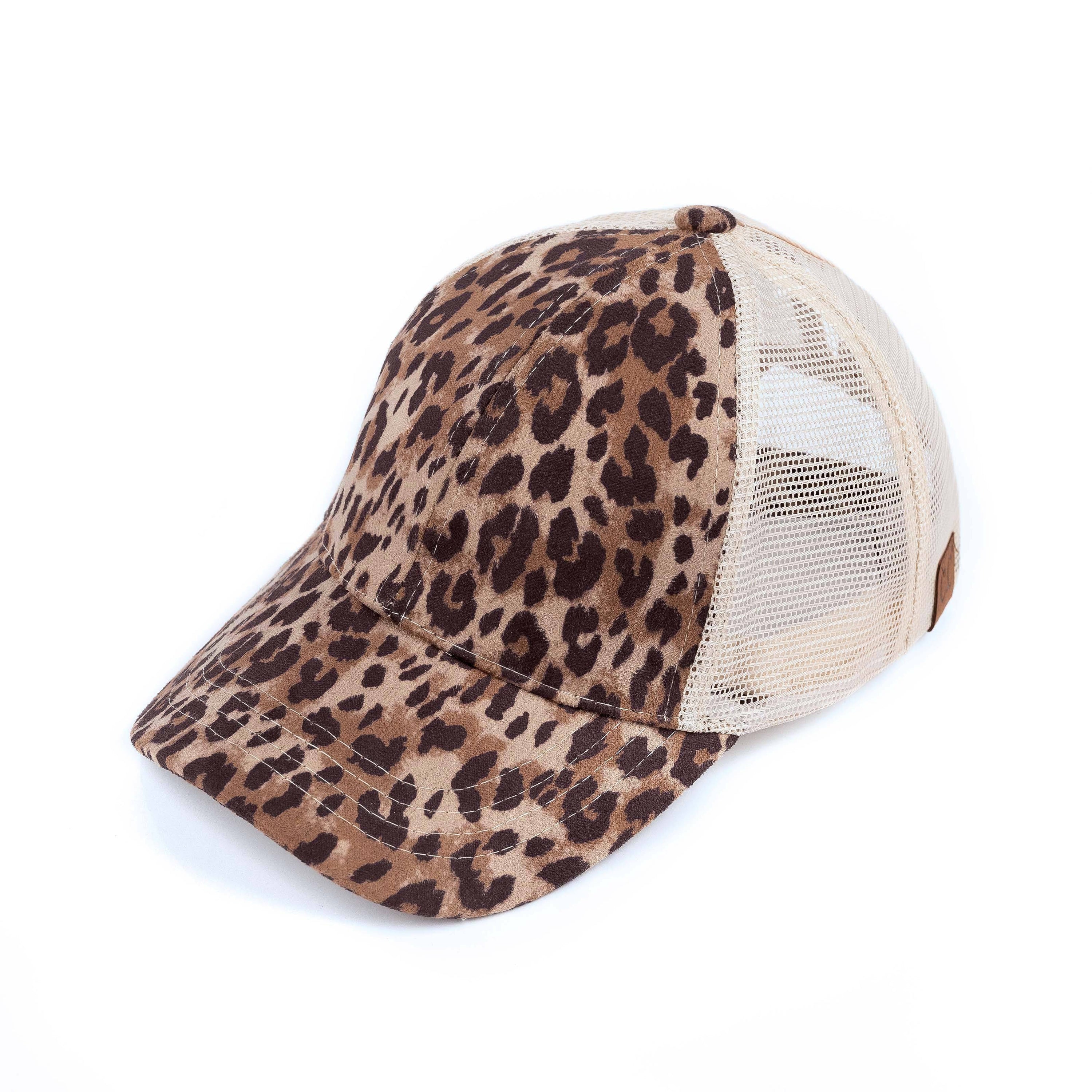 CC Faux Suede Leopard Hat featuring criss-cross and ponytail openings, showcasing its stylish leopard pattern and adjustable strap.