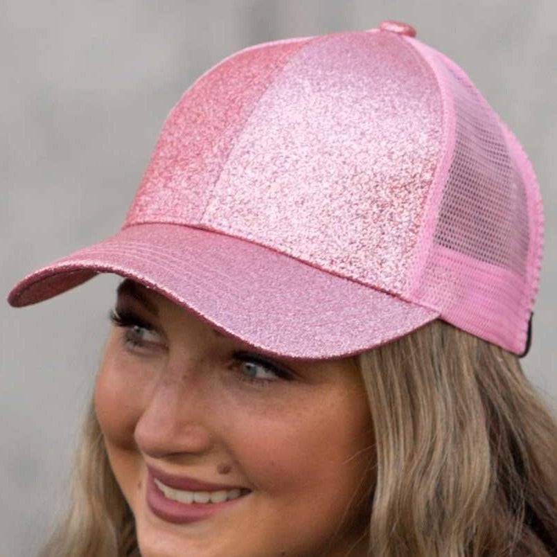 CC Glitter Messy Bun Pony Cap featuring a glitter pattern, ponytail opening, and adjustable velcro strap, suitable for women and kids.