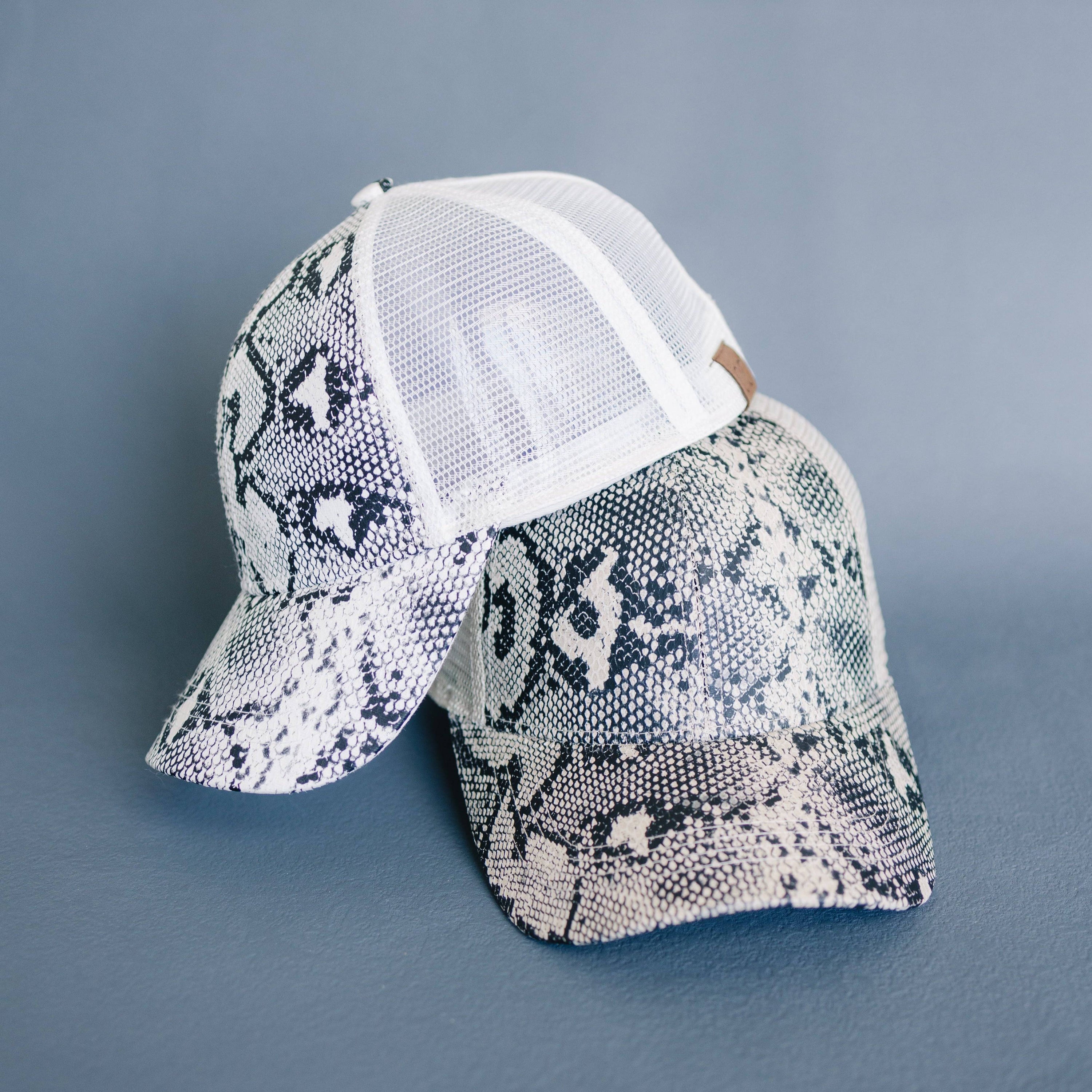 CC Popular Pattern Messy Bun Pony Cap featuring a stylish snake skin pattern, adjustable Velcro strap, and breathable mesh back.
