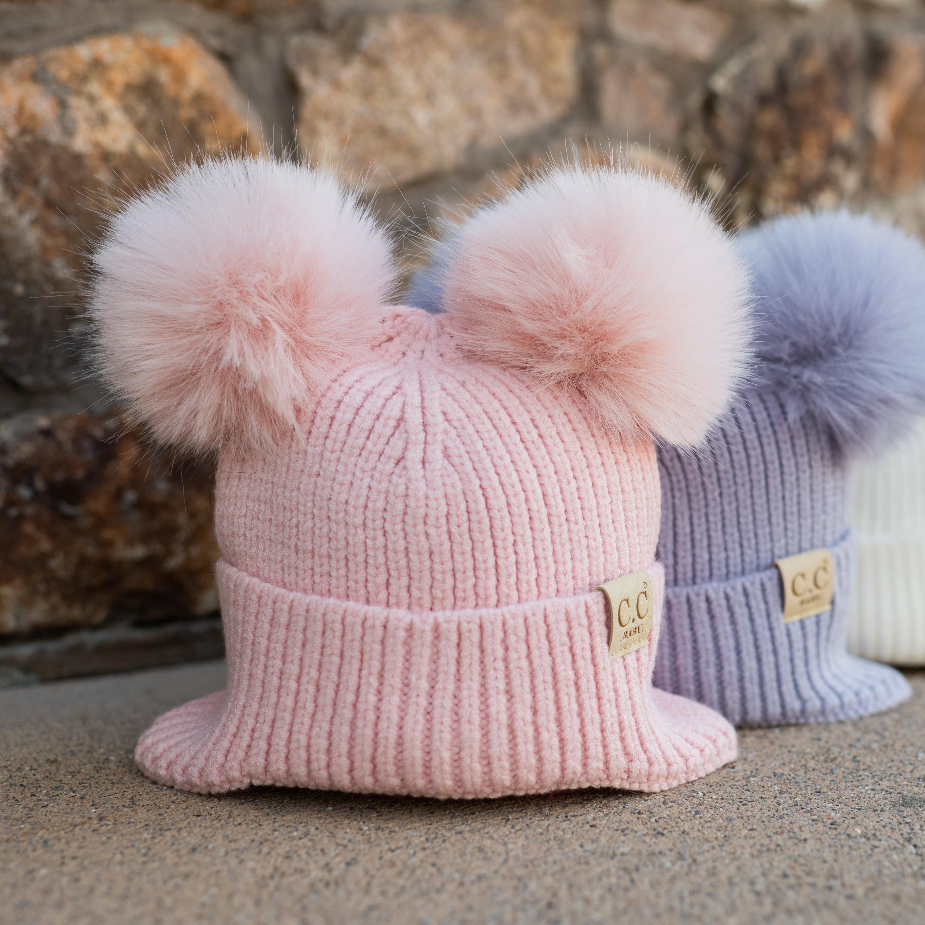 CC Toasty and Warm Ear Flap Baby Beanie with double faux fur pom-poms, designed for warmth and comfort, perfect for infants.