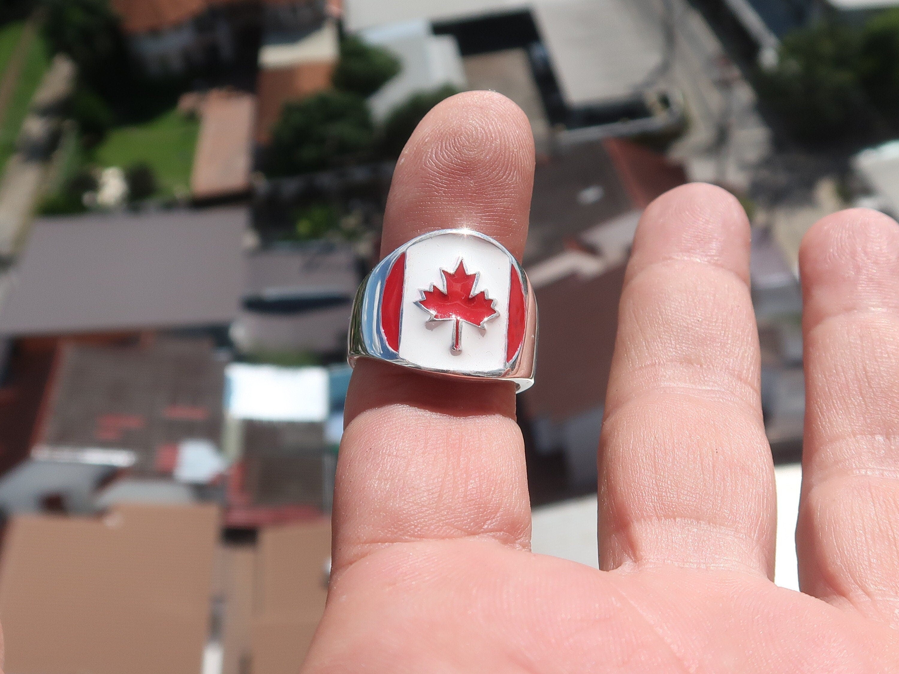 A stylish Canadian Flag Ring featuring the iconic Maple Leaf design, crafted from high-quality Sterling Silver with a mirror polished finish.