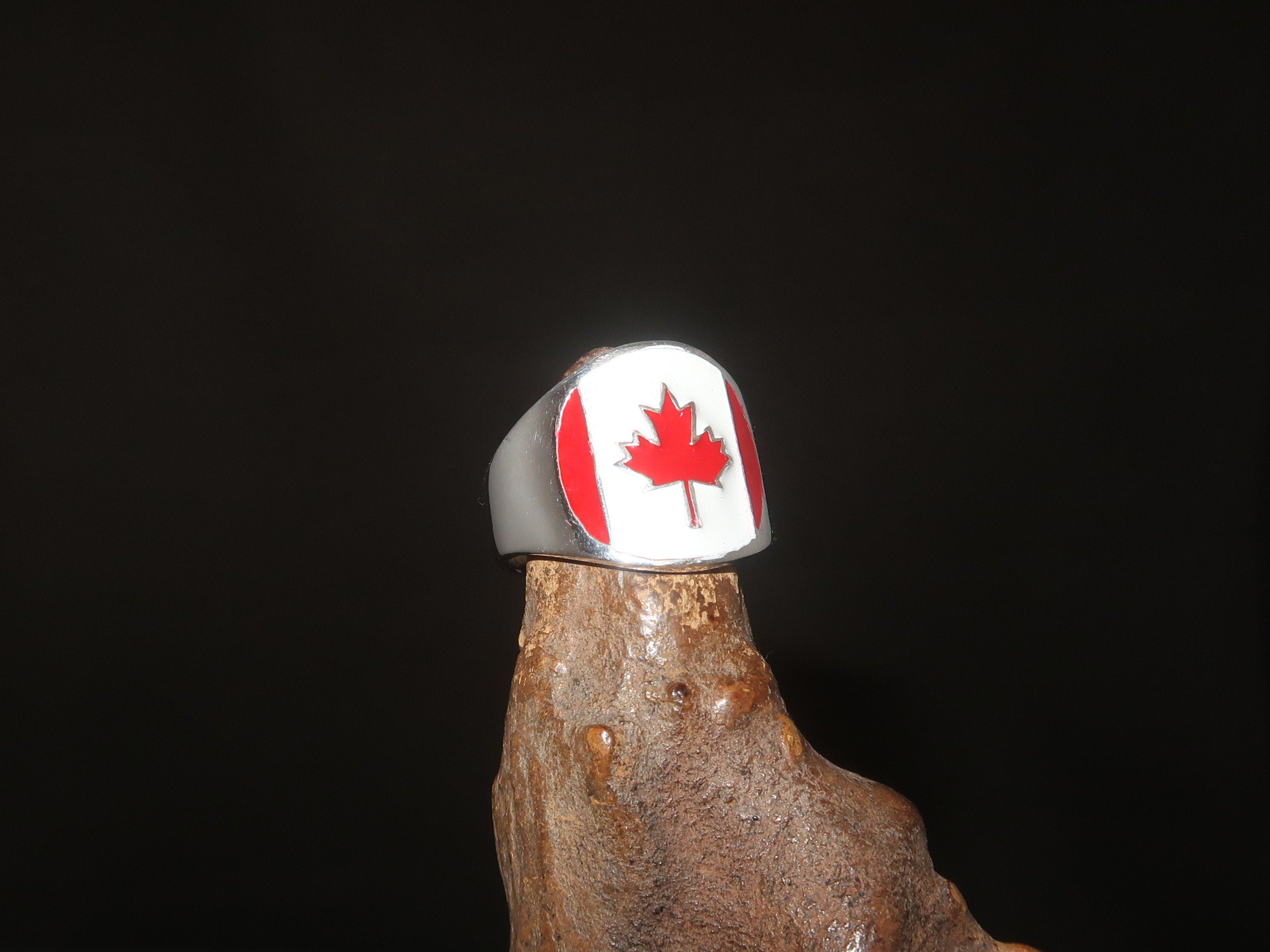 A stylish Canadian Flag Ring featuring the iconic Maple Leaf design, crafted from high-quality Sterling Silver with a mirror polished finish.