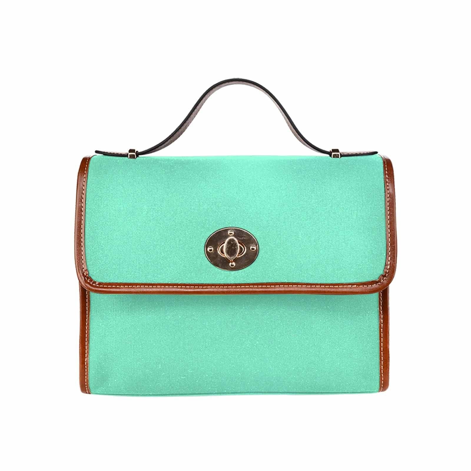 Aquamarine green canvas handbag with brown crossbody strap, featuring two interior pockets and a zipper pocket.