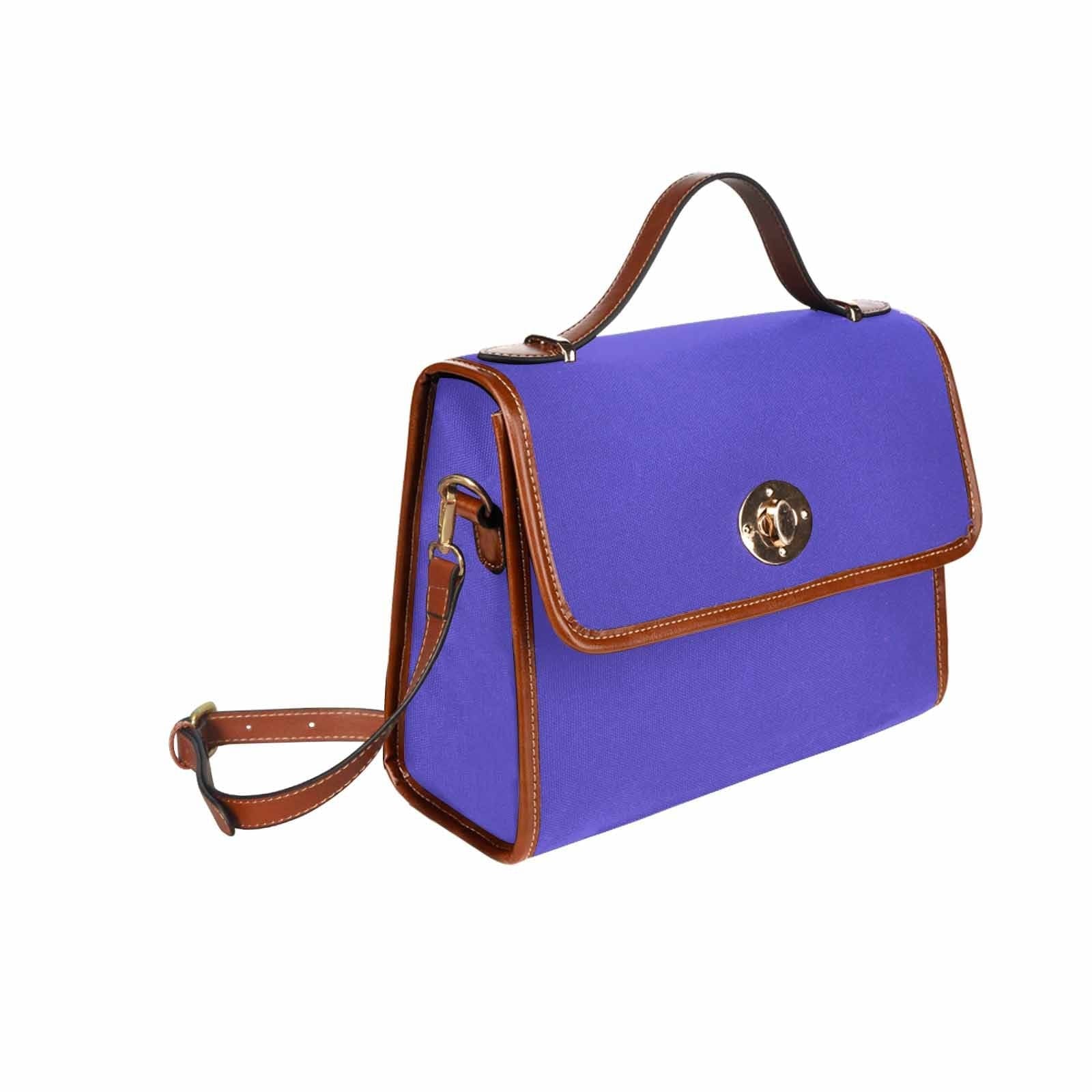 Blue Iris Waterproof Canvas Handbag with brown crossbody strap, showcasing its stylish design and durable material.