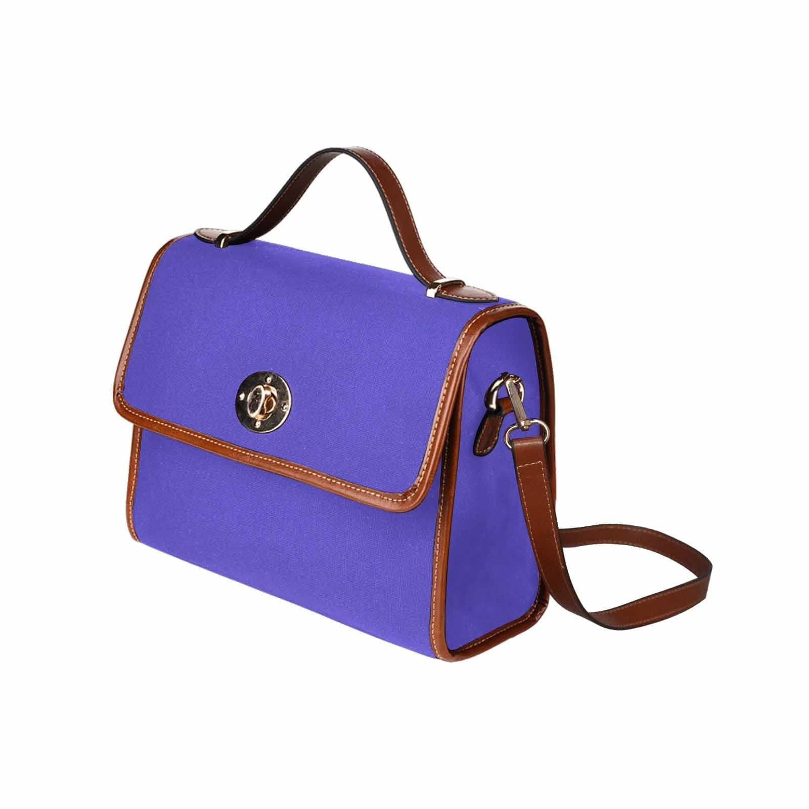 Blue Iris Waterproof Canvas Handbag with brown crossbody strap, showcasing its stylish design and durable material.